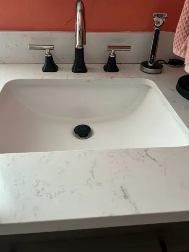 Bathroom sink and dark faucet