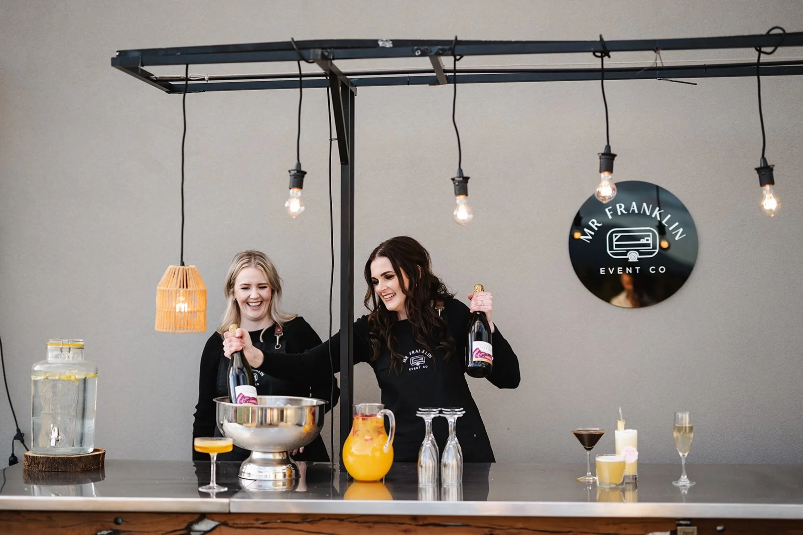 Women serving drinks at a bar