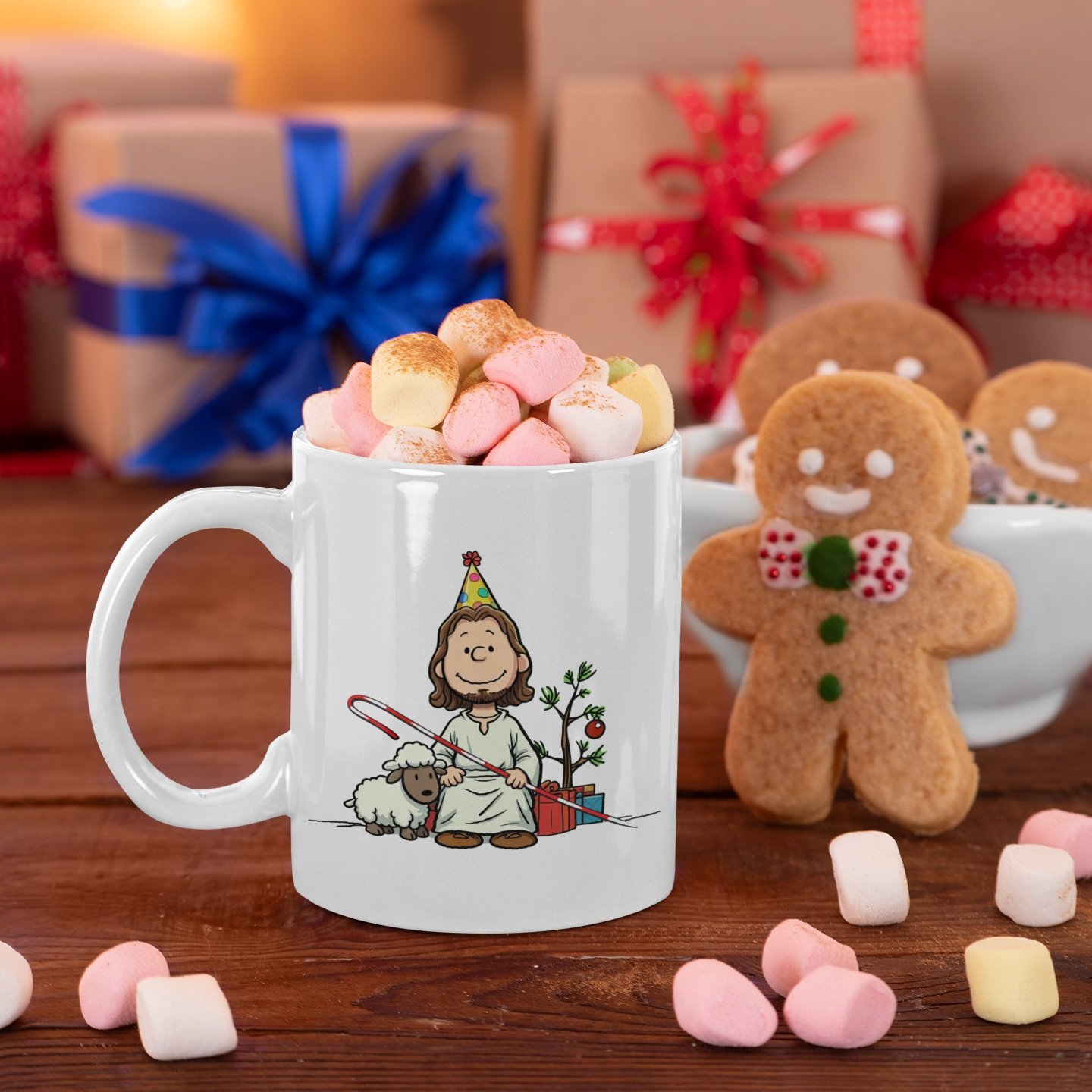 Lights and presents in background with gingerbread man cookies and white ceramic mug with image of Jesus drawn in Peanuts style with birthday hat and Christmas decor