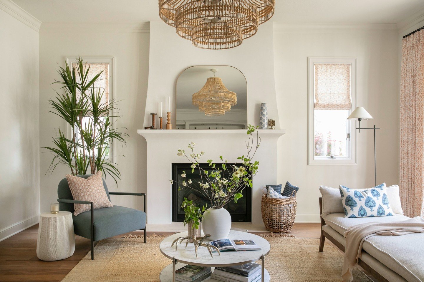 Designing this formal sitting room at our #35thstreetproject was a dream - layered textures, custom touches, and the wood beaded chandelier pulling it all together. From the stucco fireplace to drapery, every detail was chosen to create a space that 