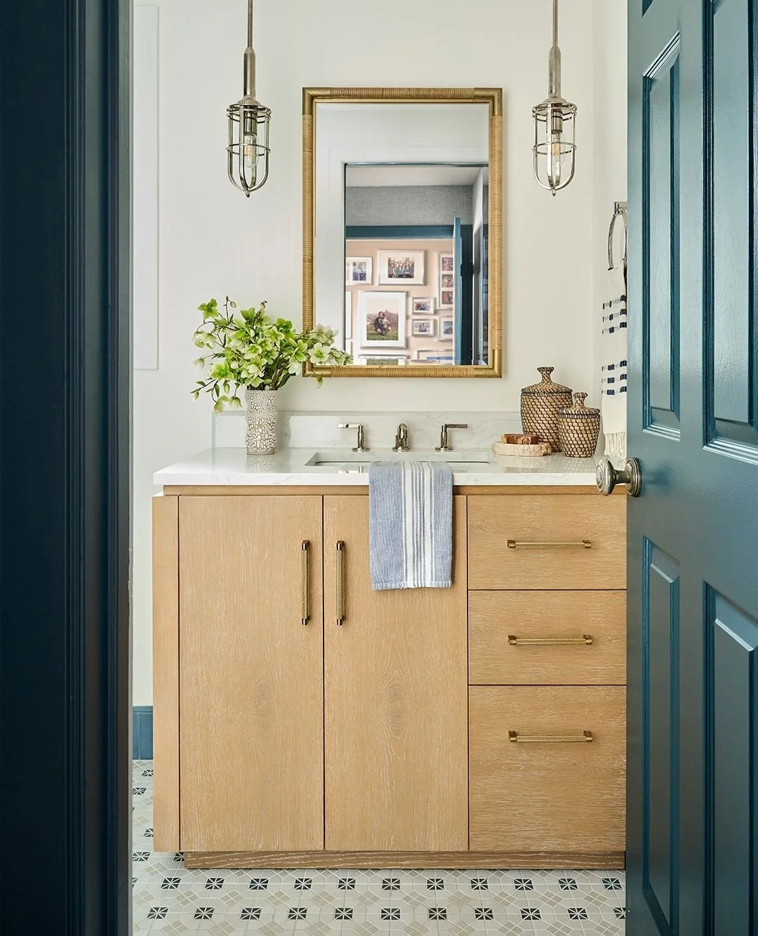 When remodeling a dual-purpose space, it&rsquo;s essential to create cohesion while still letting each room have its own flair. We achieved that by letting the deco floor tile flow seamlessly from laundry to bath, sticking to a rich deep blue accent 