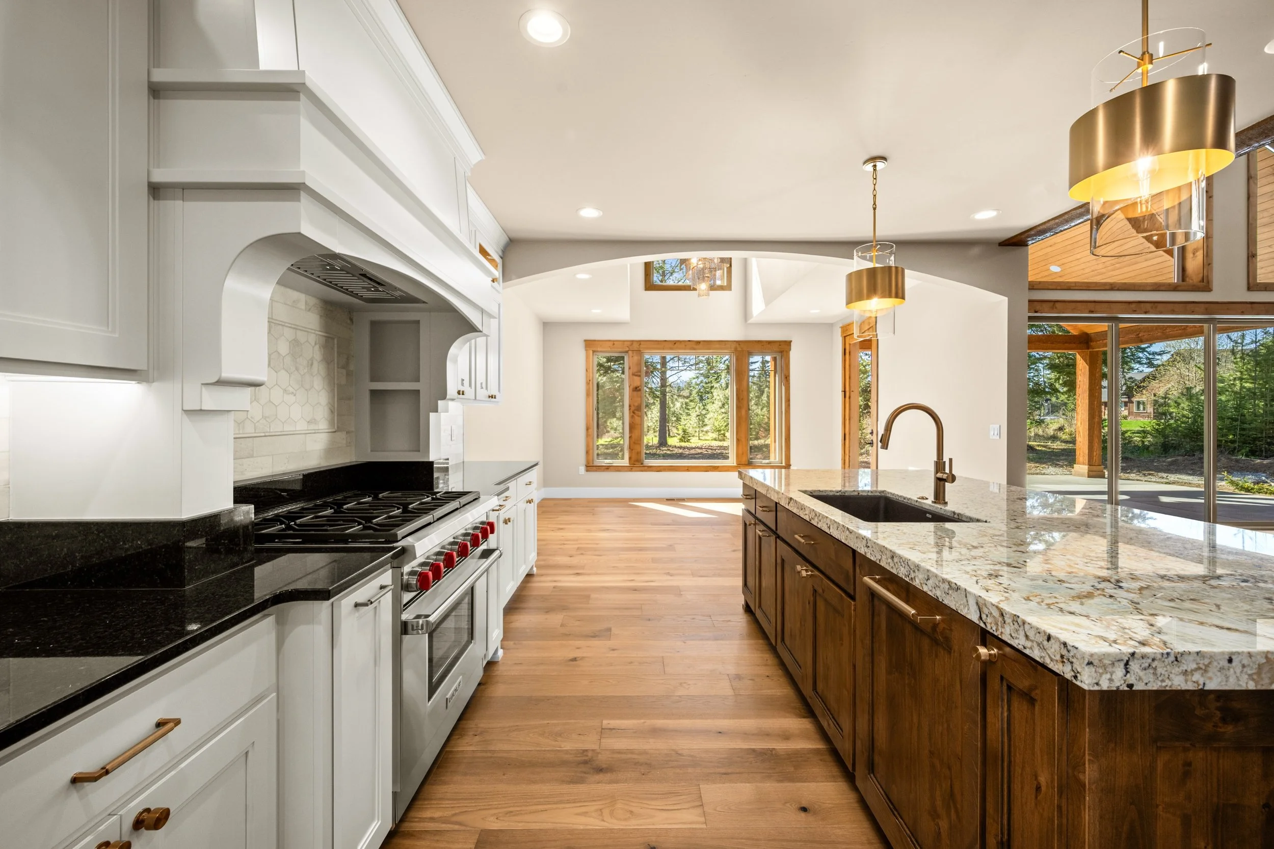 A kitchen designed for gathering, entertaining, and making memories. ✨

From the beautiful contrast of crisp white cabinetry and rich wood finishes to the statement stone countertops and custom detailing, every element of this kitchen brings together