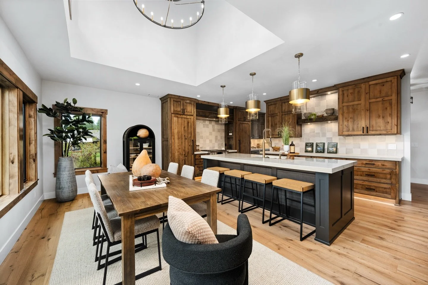 Rooted in natural texture and refined in every detail.

This space blends warm timber cabinetry with soft neutral stone, creating a kitchen that feels both elevated and inviting. The oversized island anchors the room with confident simplicity, while 