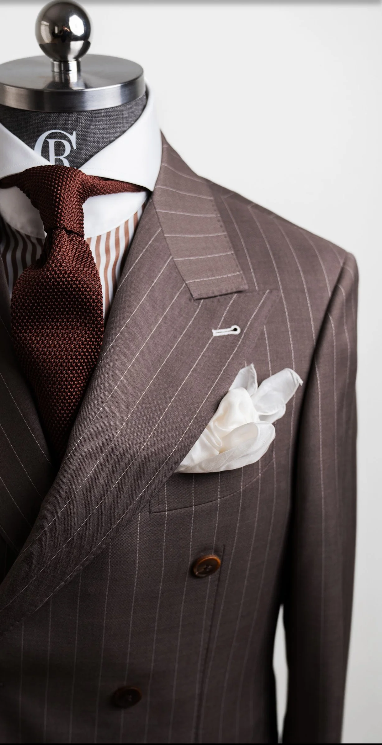 RC PINSTRIPE BROWN on a stand mannequin displaying the jacket paired with a pinstriped brown and white Raffiné Couture cutaway dress shirt