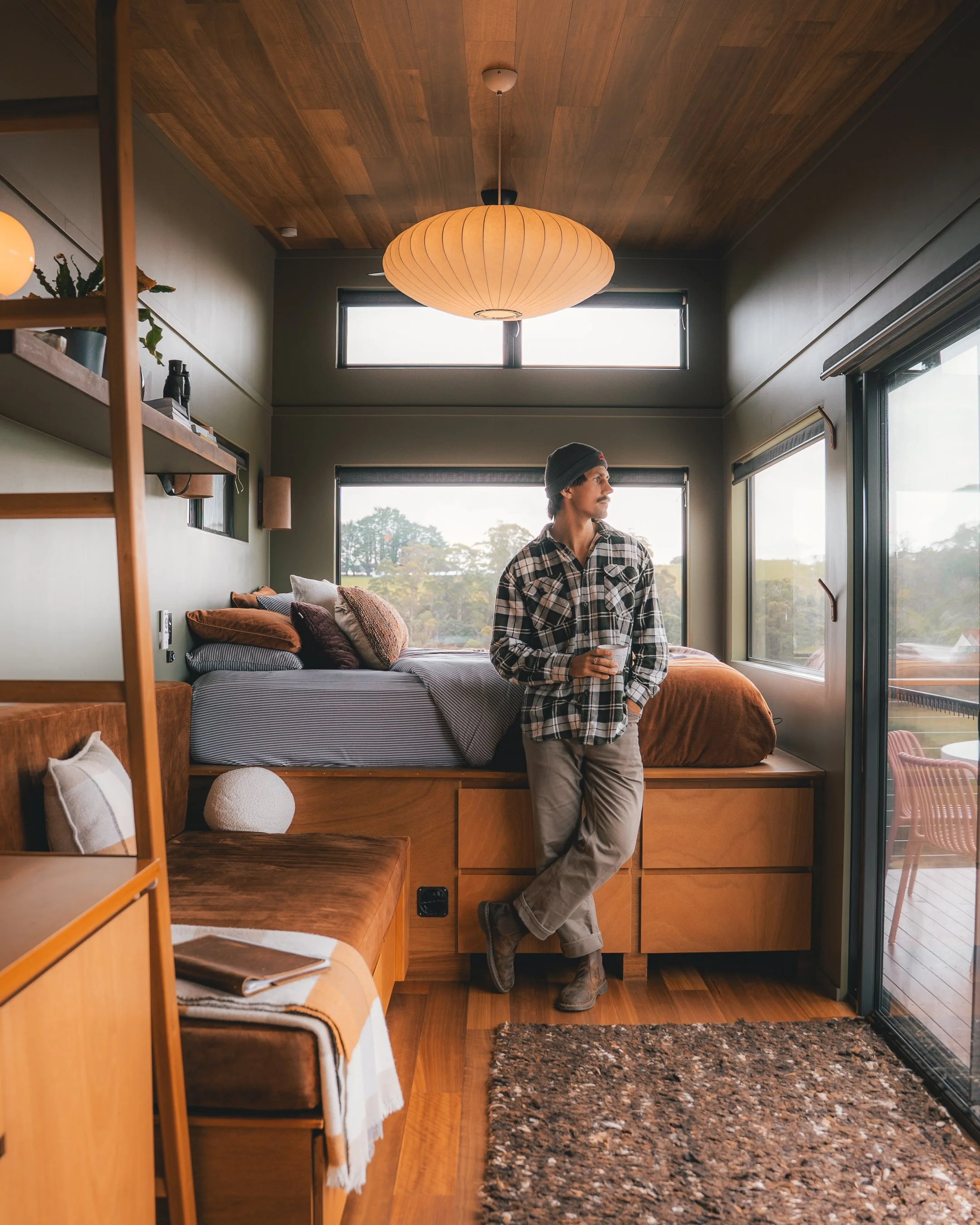 A guest standing in the living area looking rleaxed