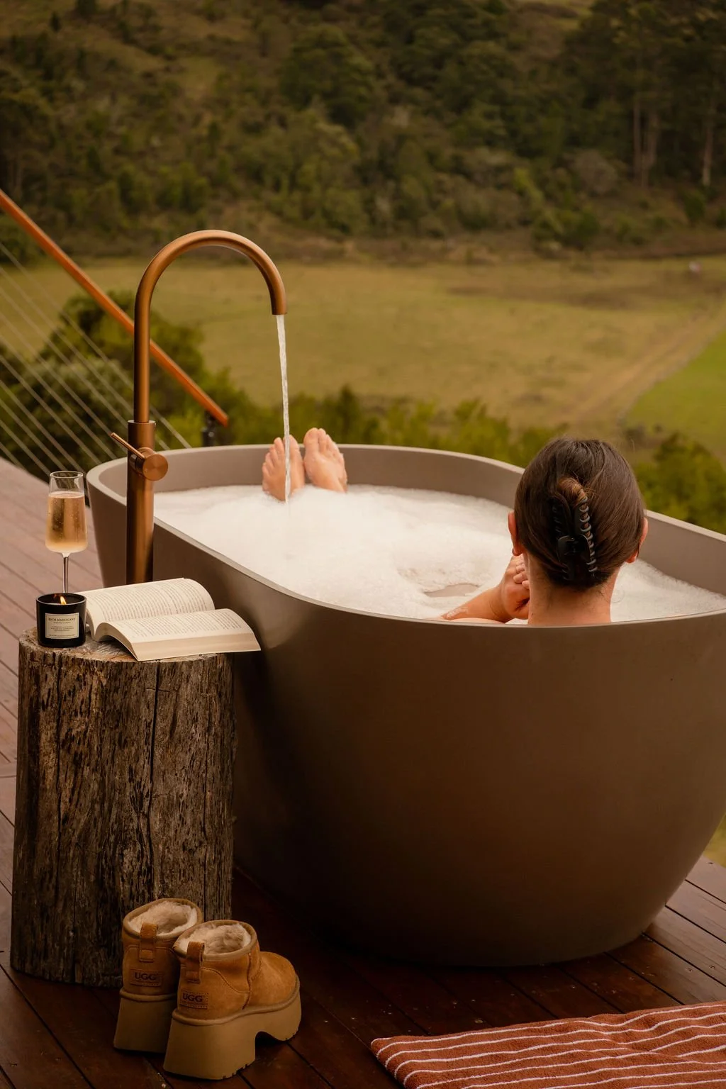 Outdoor bath on deck overlooking the ocean at an off-grid tiny home in Tasmania