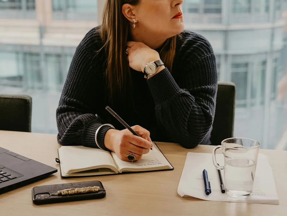 Person receiving muscle therapy with a massage tool on their thigh.