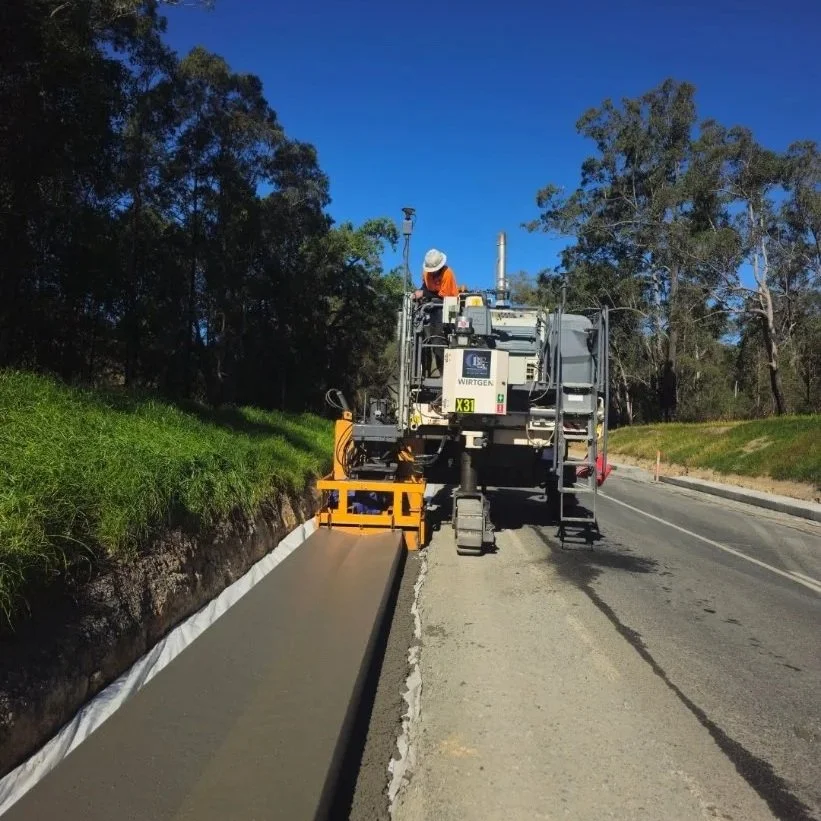 SO kerb installation. slipform kerb and channel nsw. Slipform paving. Slipform contractor Vic. Slipform Queensland. Kerb installation. F type barrier. Slipform barrier