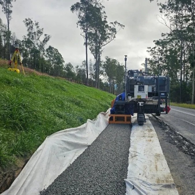 No fines installation. Slipform no fines NSW, VIC. Slipform paving. Slipform australia. Wirtgen sp15, Kerb and channel. Concrete. Civil construction. concrete contractor. slipform barrier. slipform feed troughs