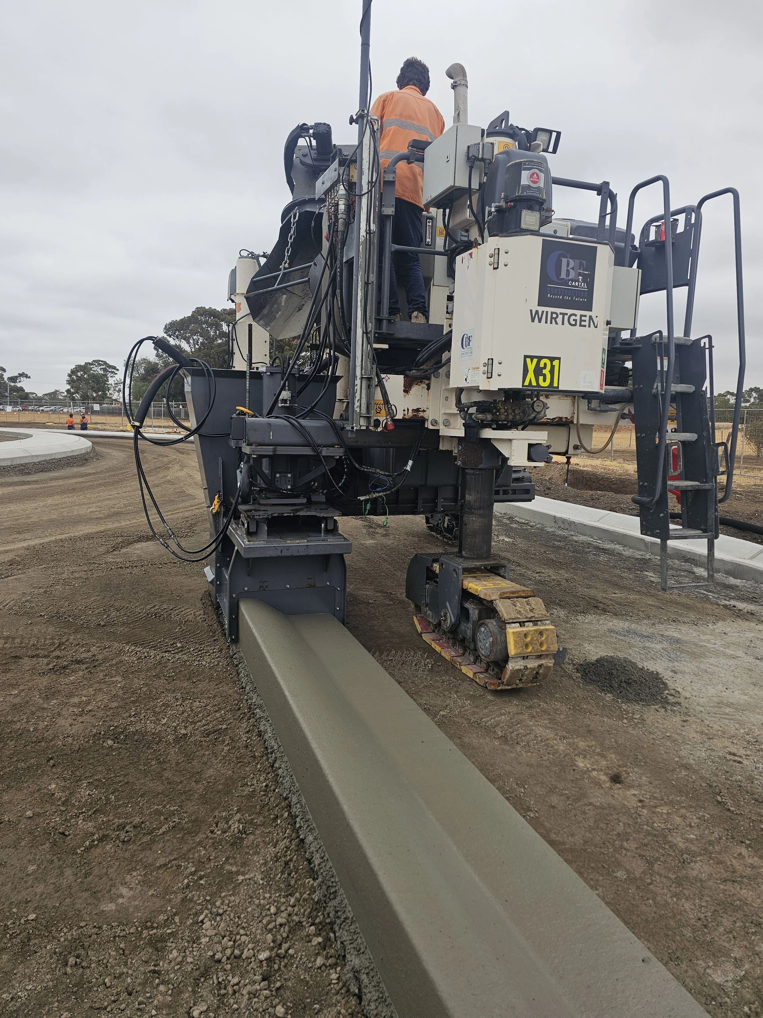Top kerb and channel contractors Victoria, installing kerb with slipform paver in melbourne