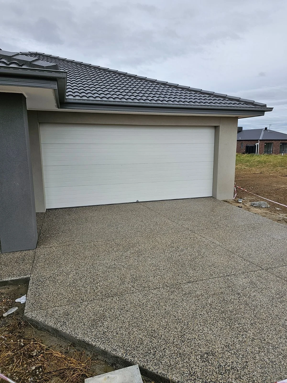 Exposed aggregate driveway (decorative concrete) with saw cuts for crack prevention. Exposed aggregate geelong. Melbourne. Ballarat. Driveway installation. Concrete driveway