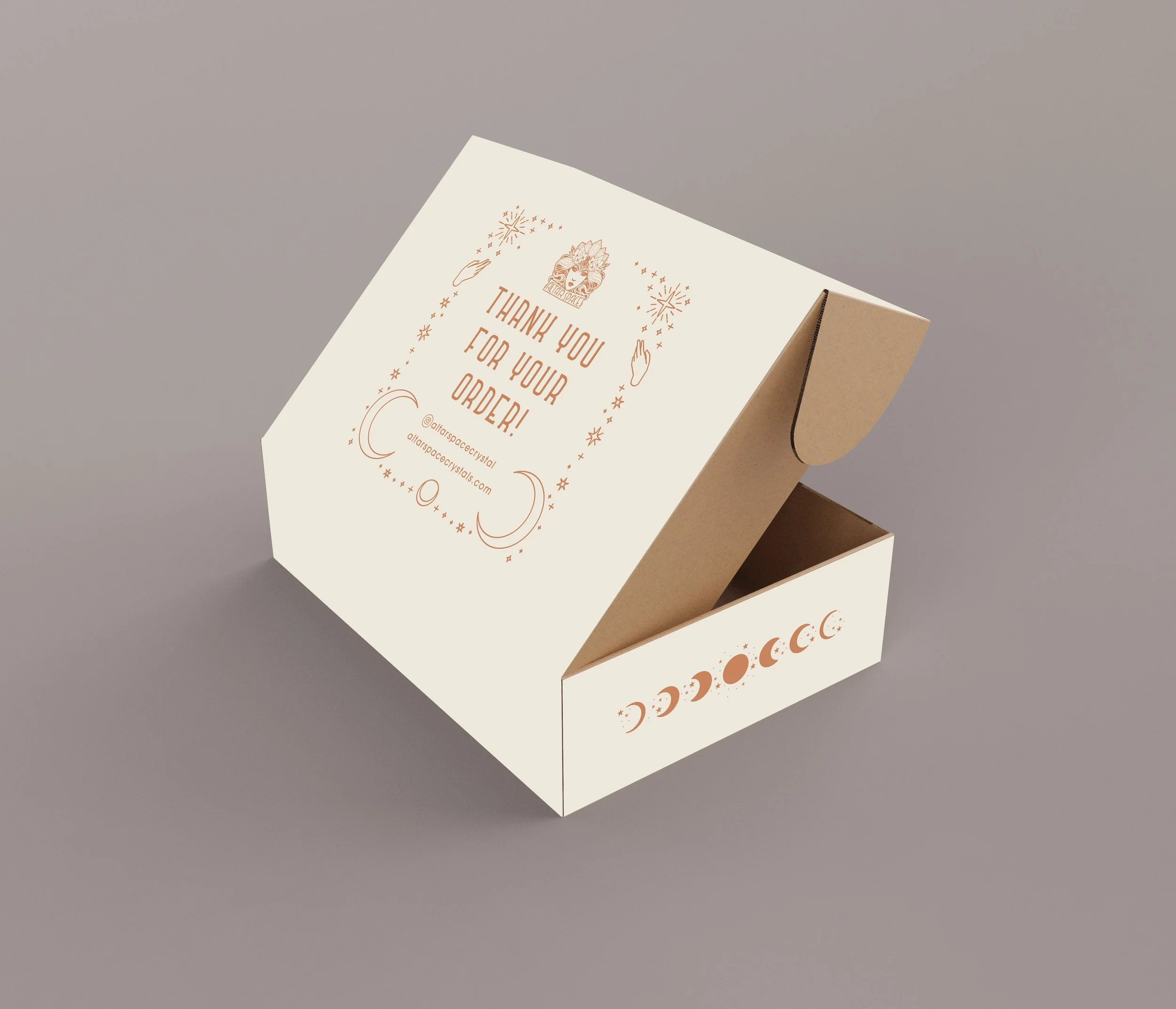 Decorative cardboard box with "Thank You For Your Order!" printed in orange lettering, featuring celestial designs and a website address on a light background.