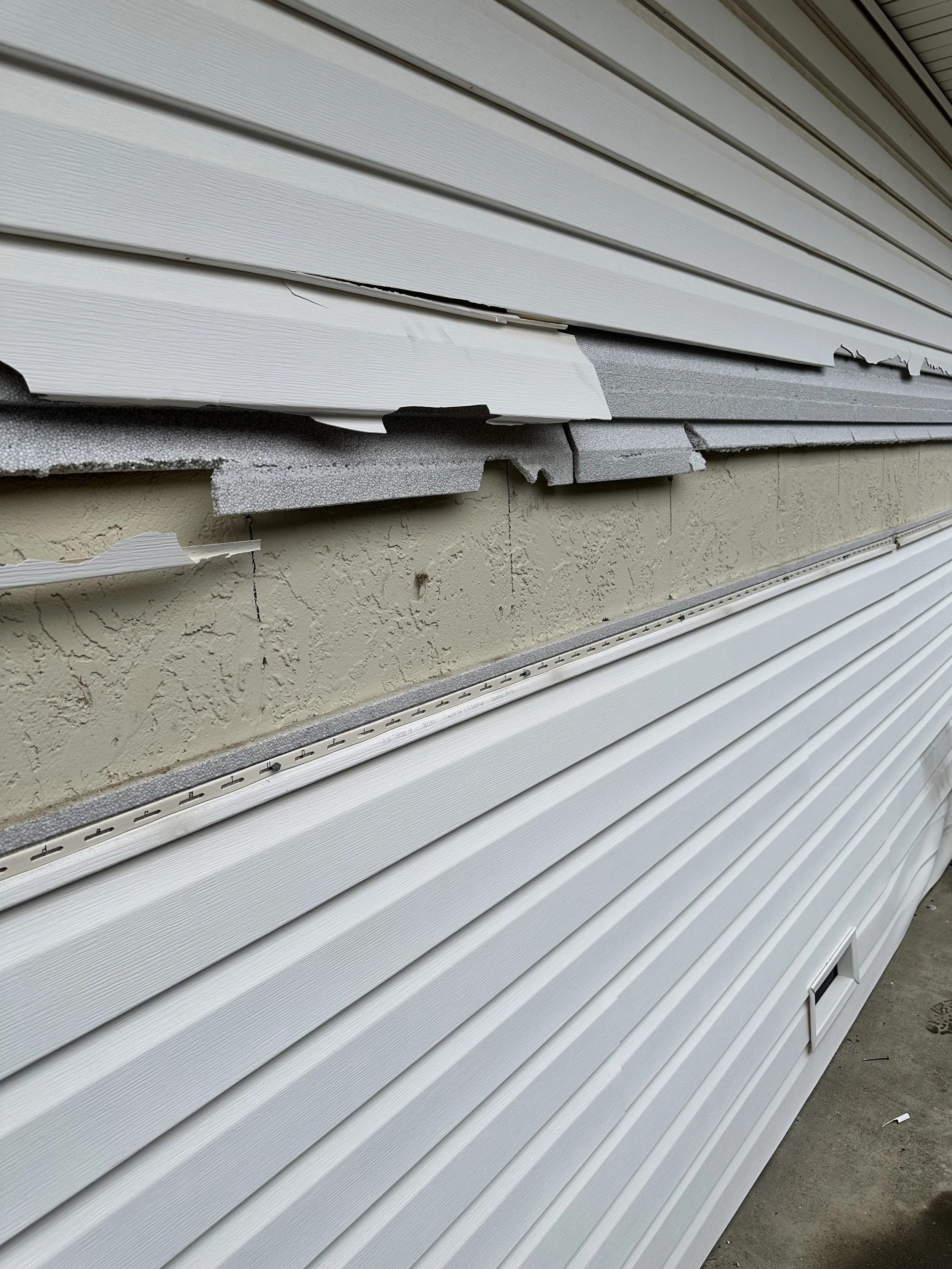 Siding repair work on a damaged Sacramento home exterior