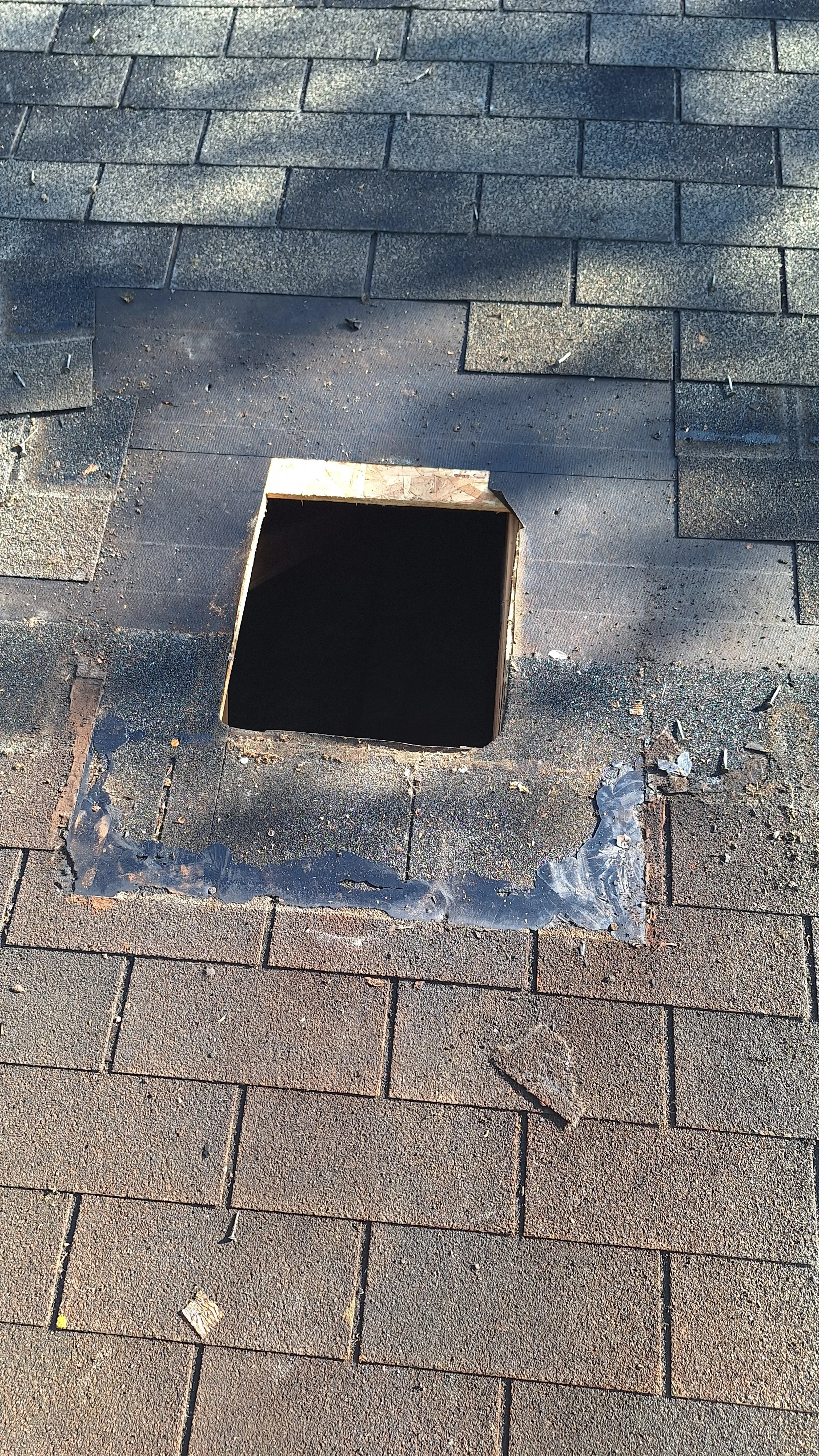 Roof with missing shingles and a square hole