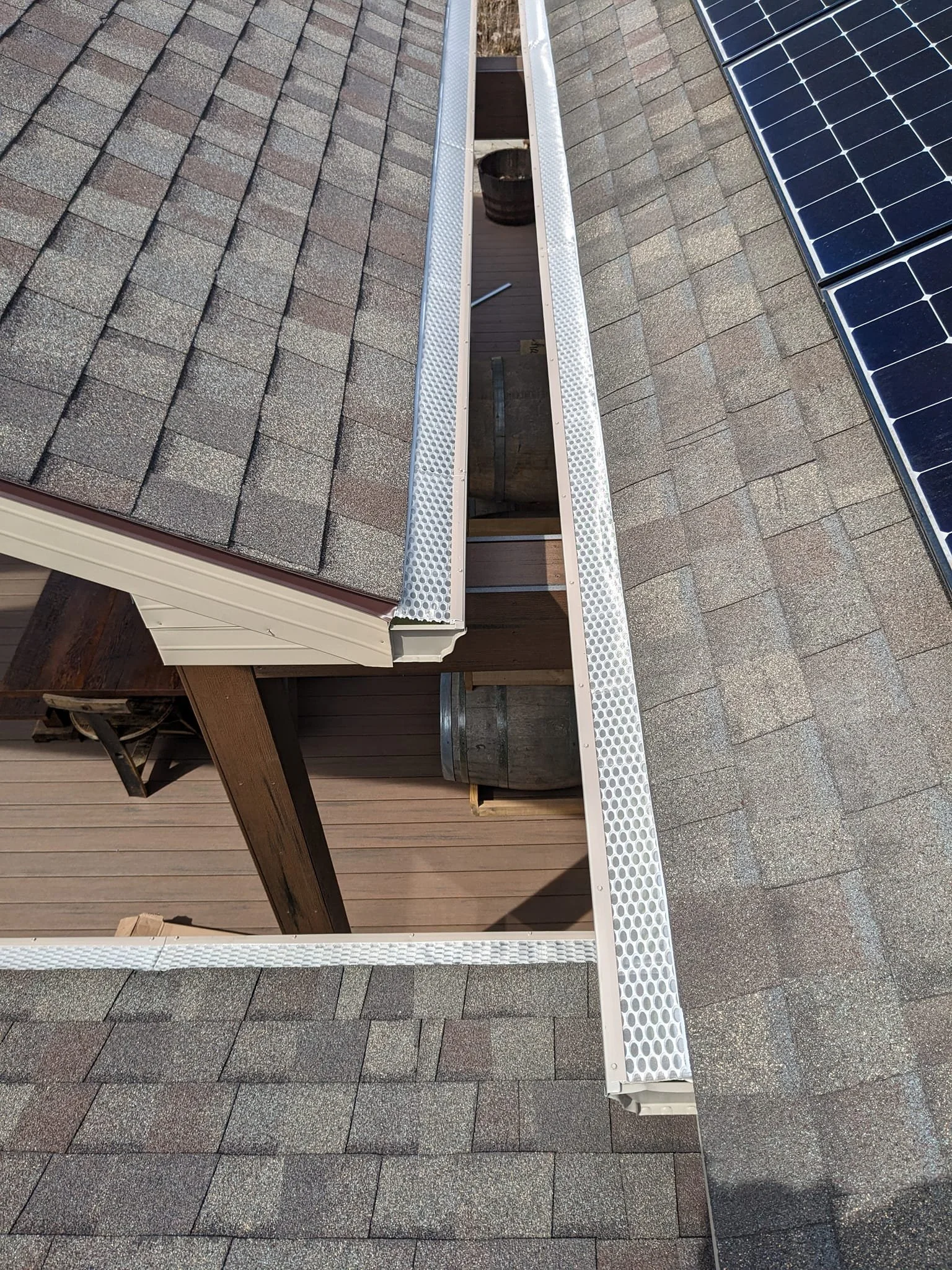 Roof with solar panels and gutter system