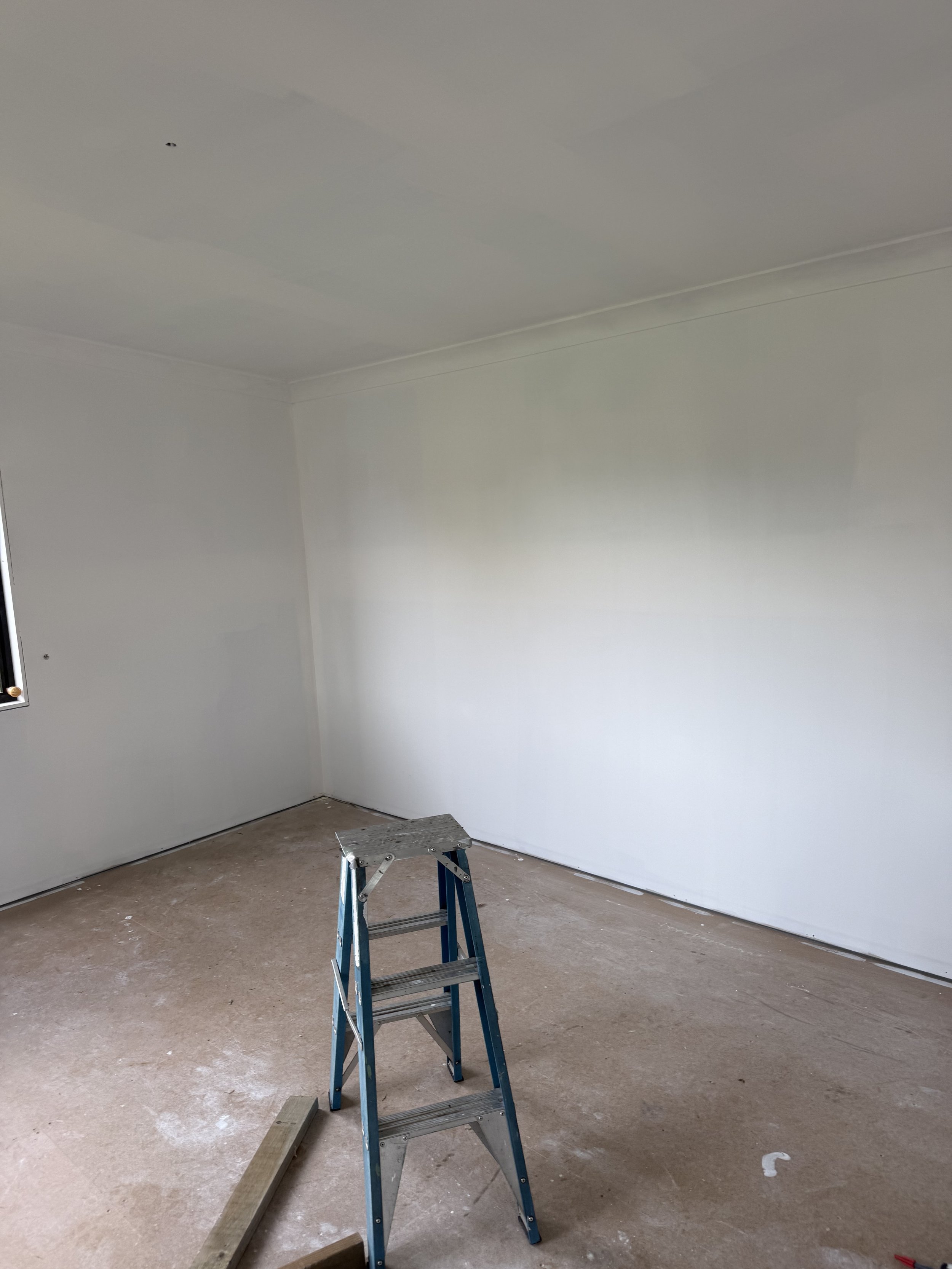 Tiny home interior undercoating, including first coat preparation to walls and ceilings.