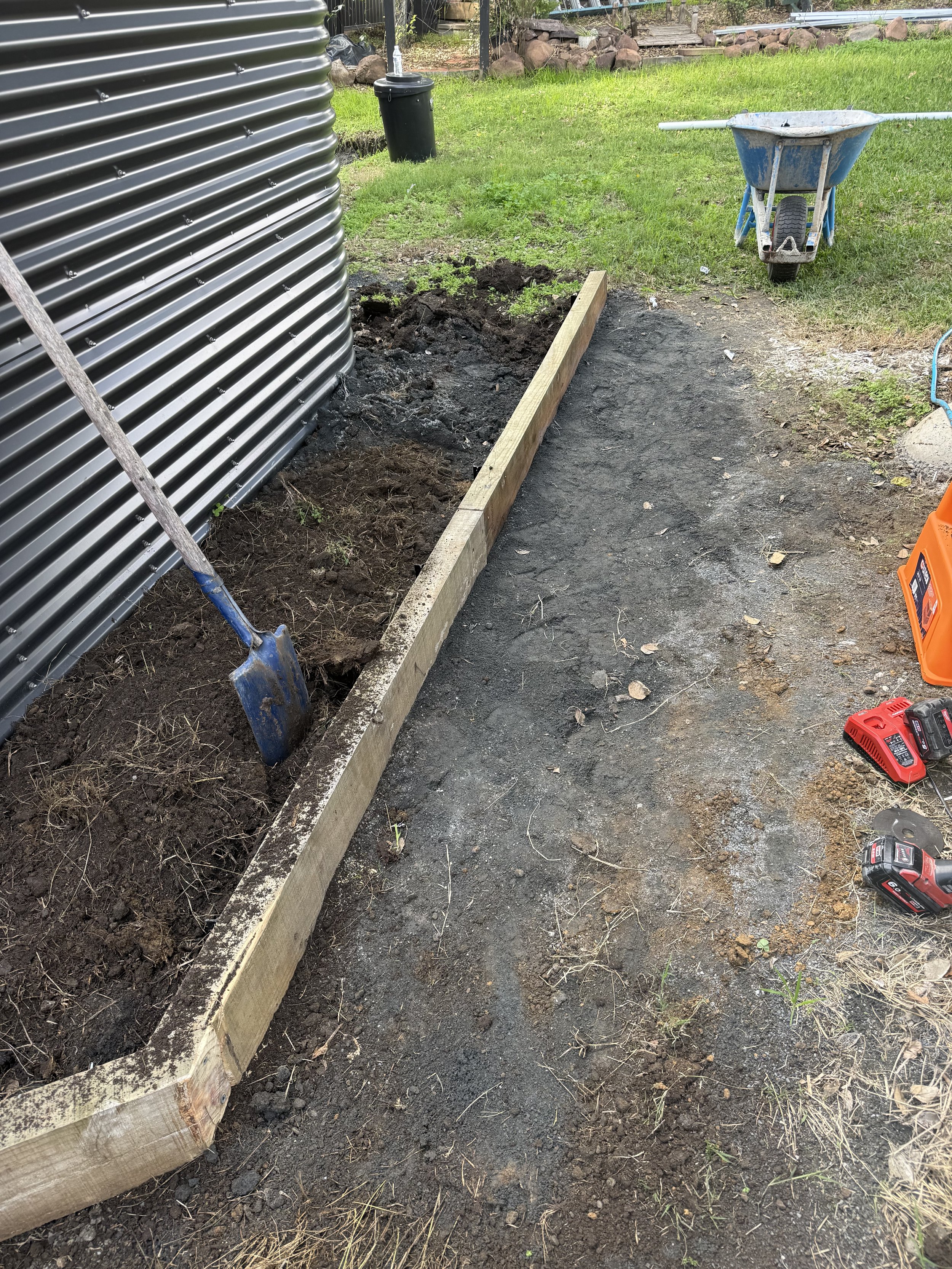 Retaining wall and drainage work to divert water awayfrom tank pad and protect site from flooding.
