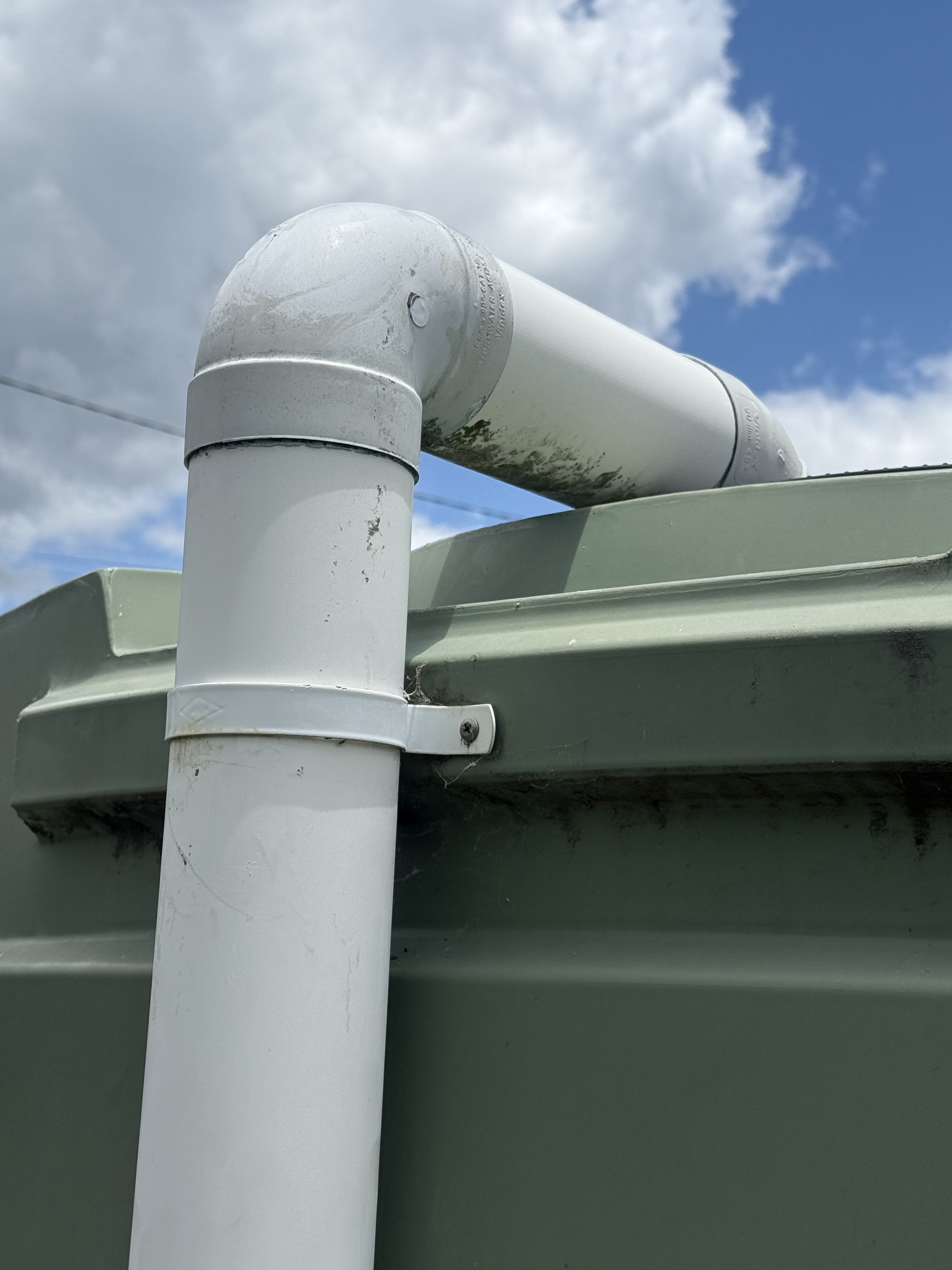 PVC downpipe connection to poly rainwater tank for household and rural supply.