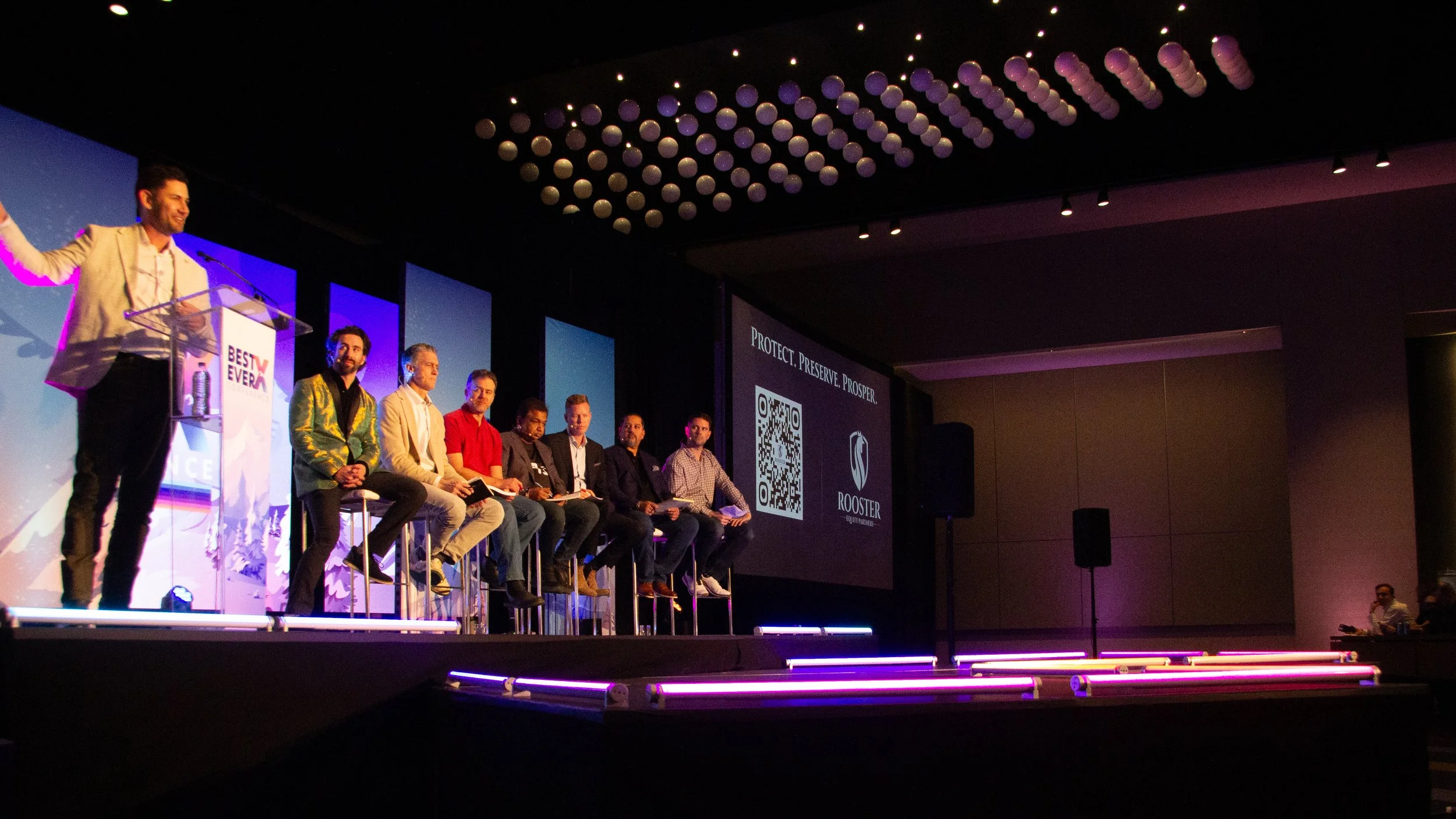 A wider view of the production environment with the panel in session. The stage design holds up at this scale, which is the real test.