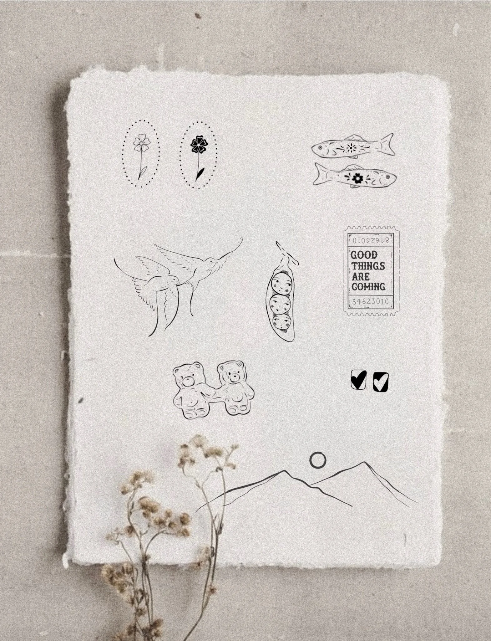 A sheet of paper with various black and white illustrations including flowers, fish, a bird, snow peas, two teddy bears, mountain sketches, and a stamp with the quote 'Good Things Are Coming', and two ticked checkboxes.