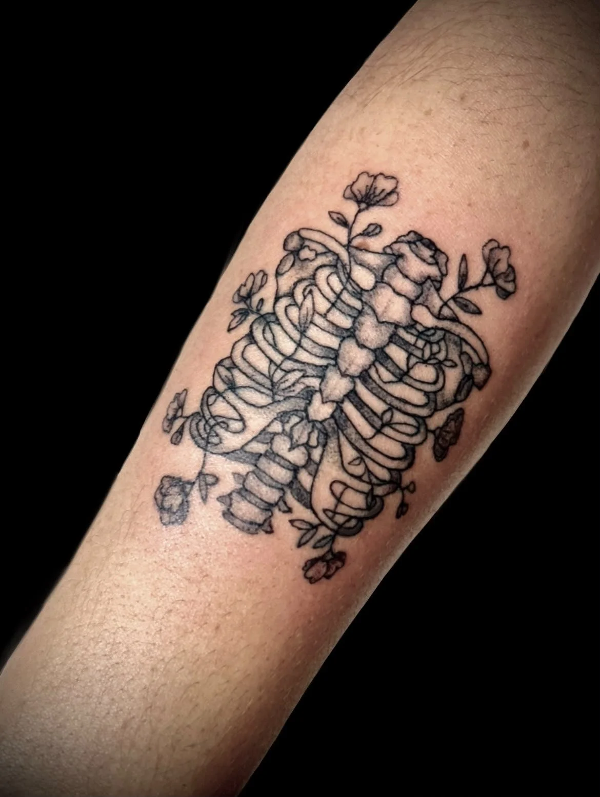 Tattoo of a dog with a horse head, connected by a string to a bucket.