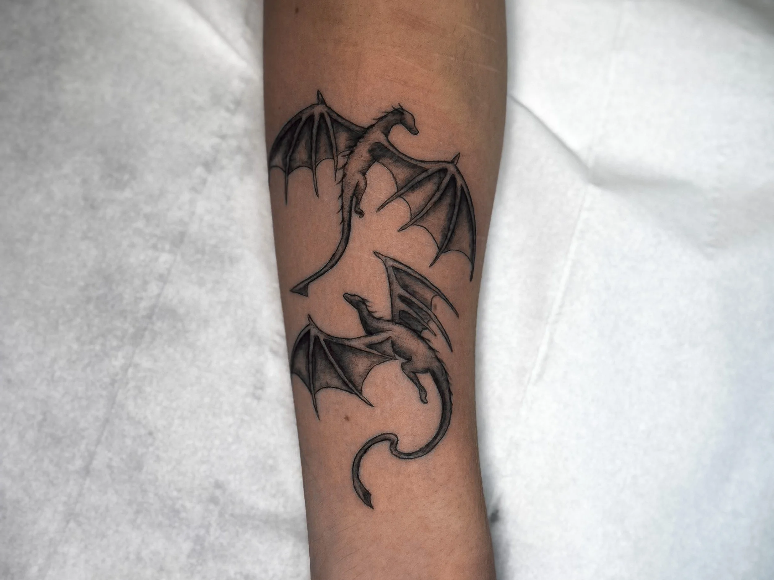 Tattoo of a human profile with tiger stripes on the face and a brain wrapped in a chain on top.