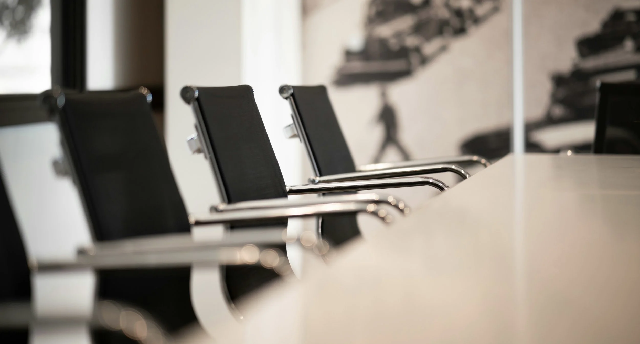 Photo of five office chairs facing a table