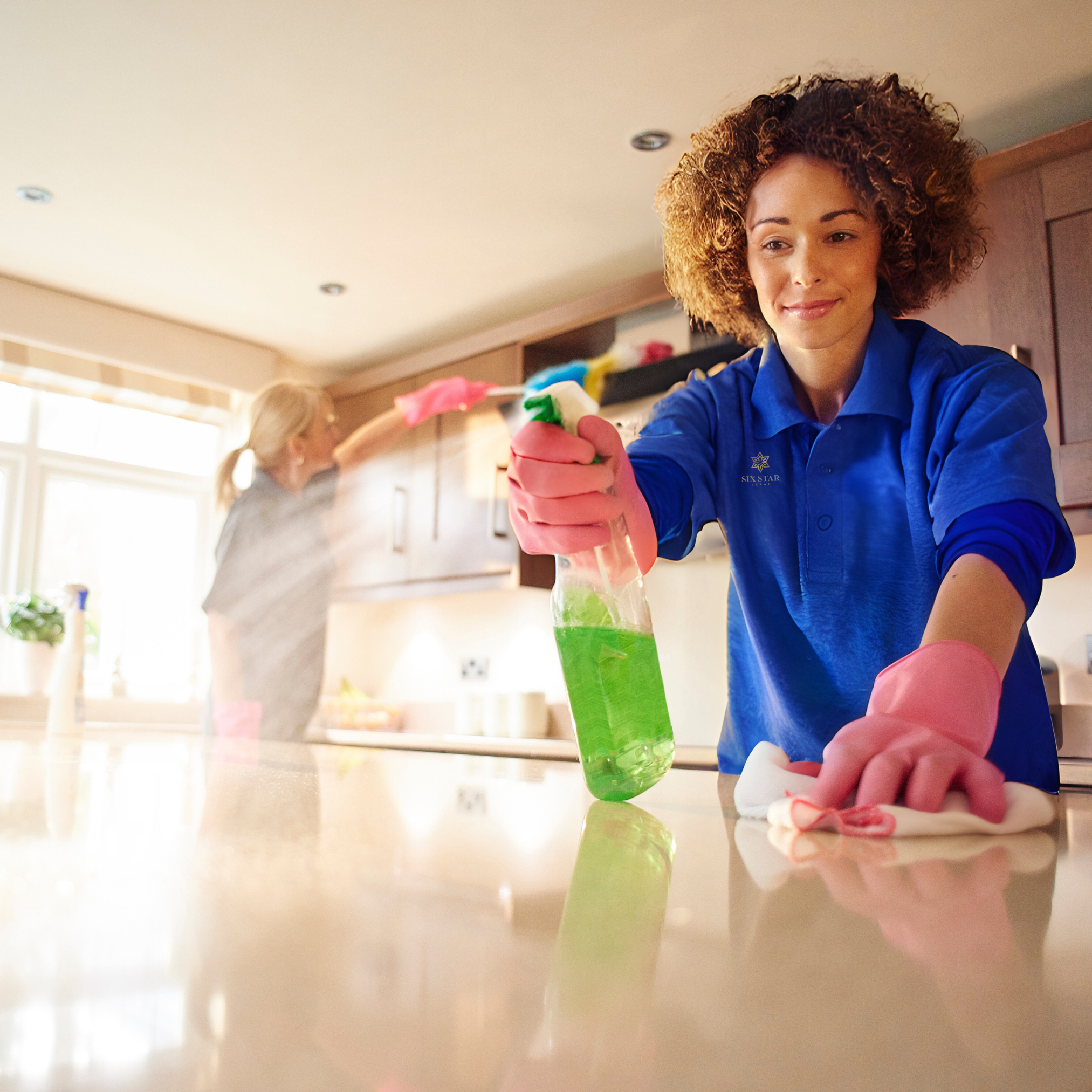 Six Star Clean house cleaner spraying cabinet