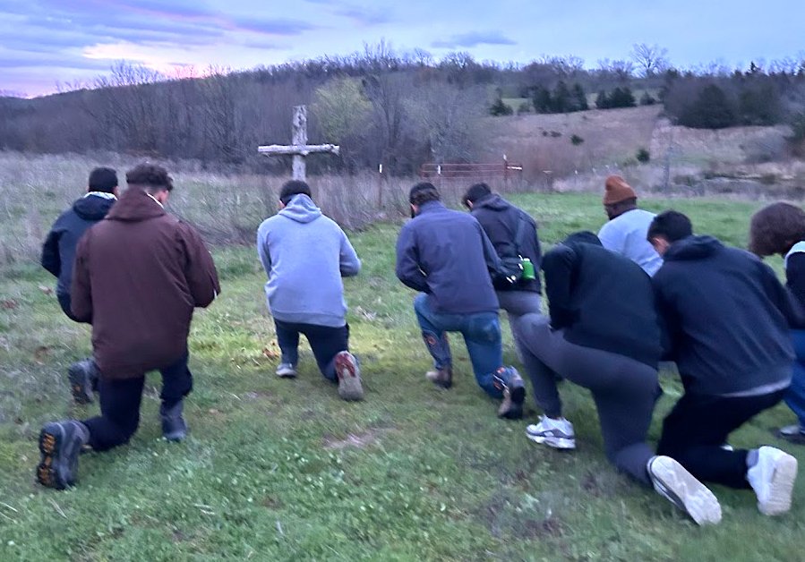 College men pray to start their long, hot workday