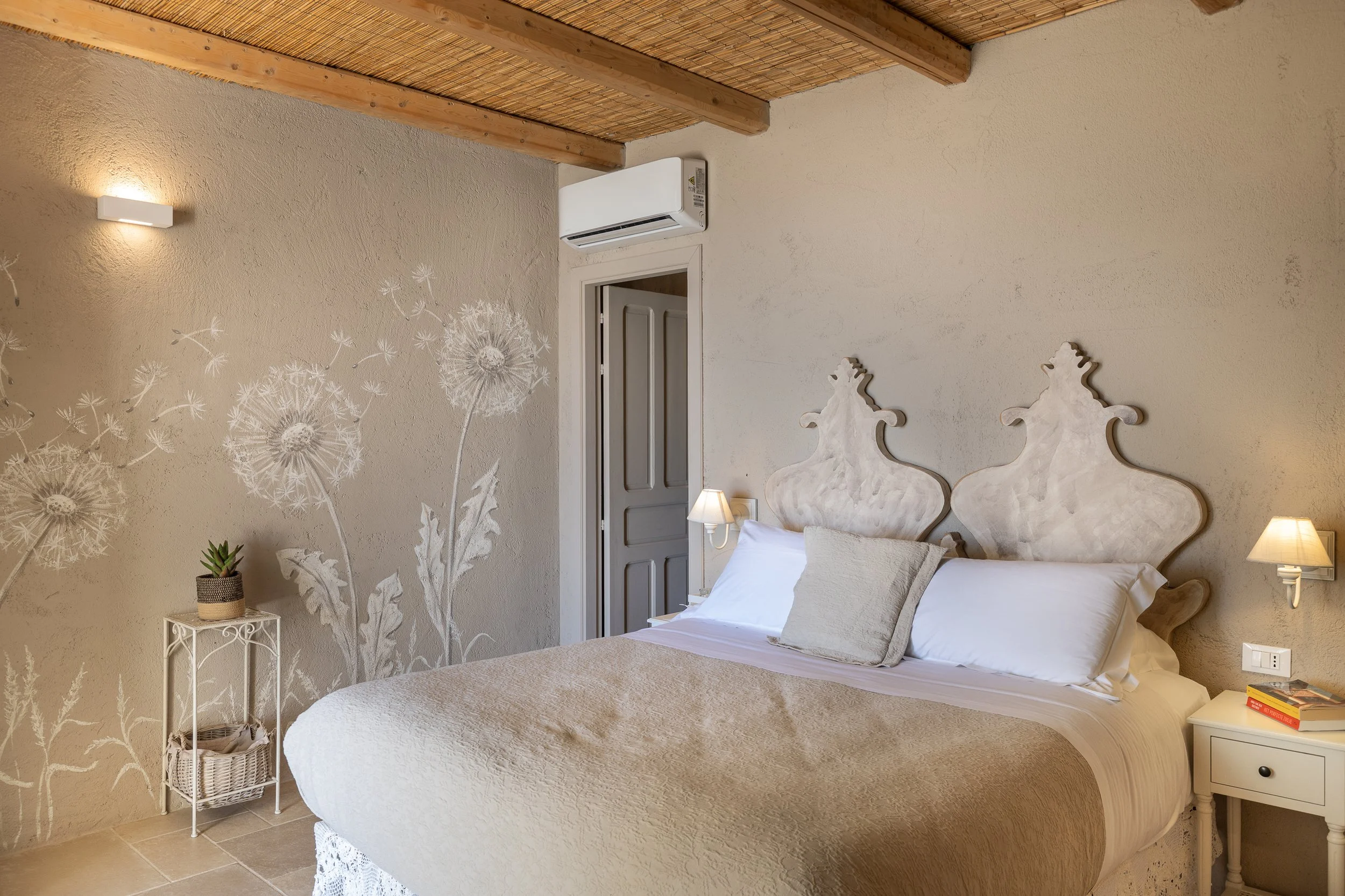 luxury bedroom with neatly made bed and bed side lamp