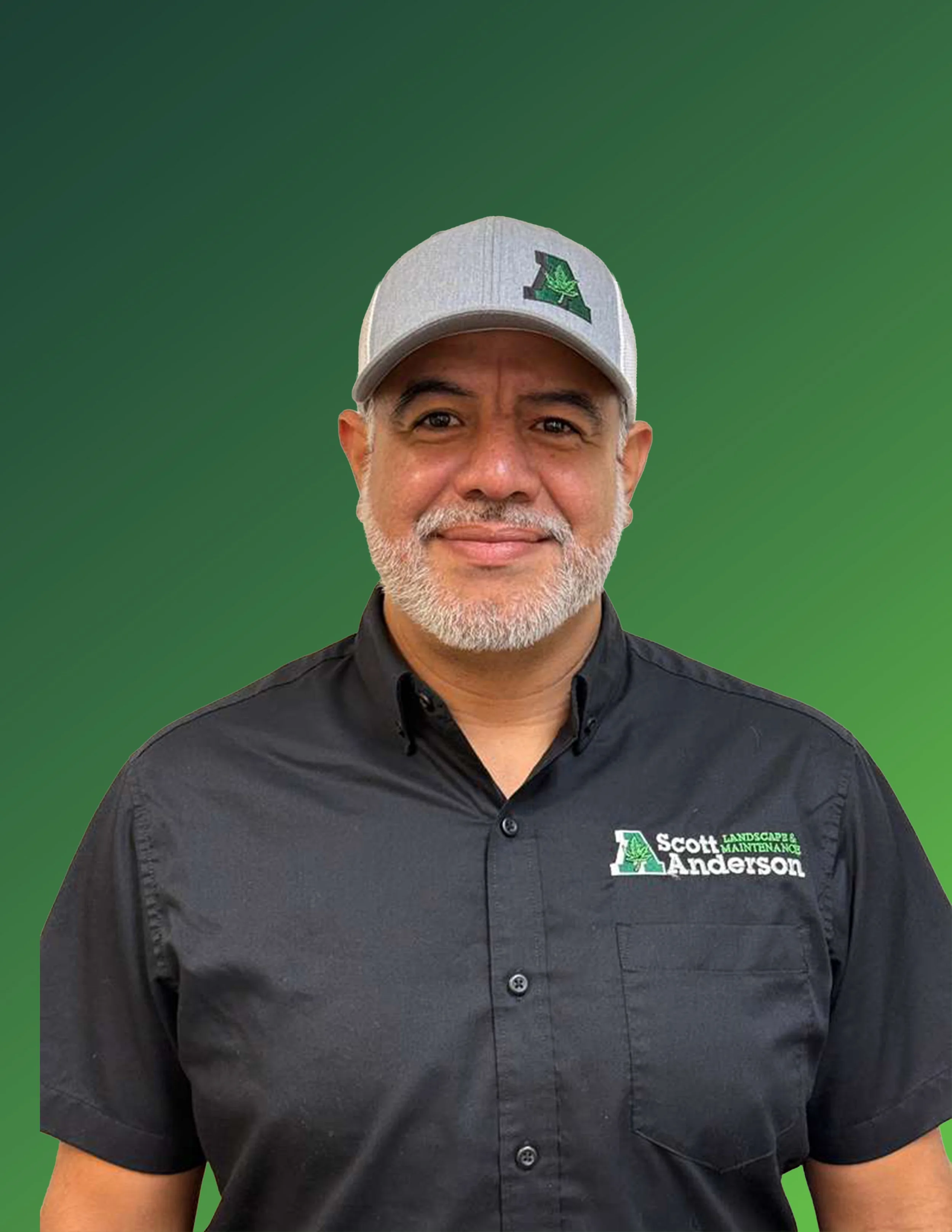 A man with a beard and gray hair wearing a gray baseball cap with a green logo and a black button-up shirt with a company logo that reads 'Scott Anderson Landscaping & Maintenance' against a green background.