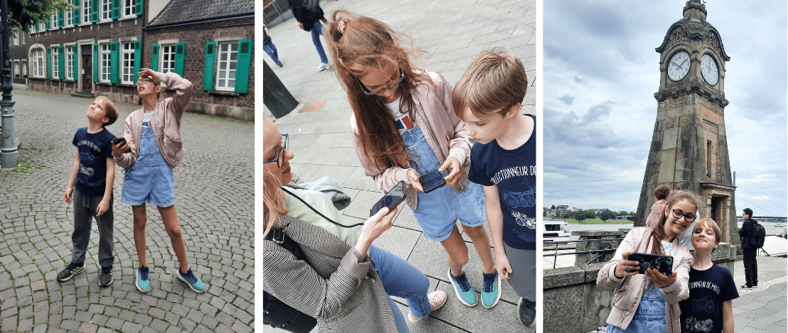 Familie mit zwei Kindern entdeckt Düsseldorf bei einer Stadtrallye – unterwegs mit Smartphone bei einer Schnitzeljagd für Kinder in der Innenstadt.