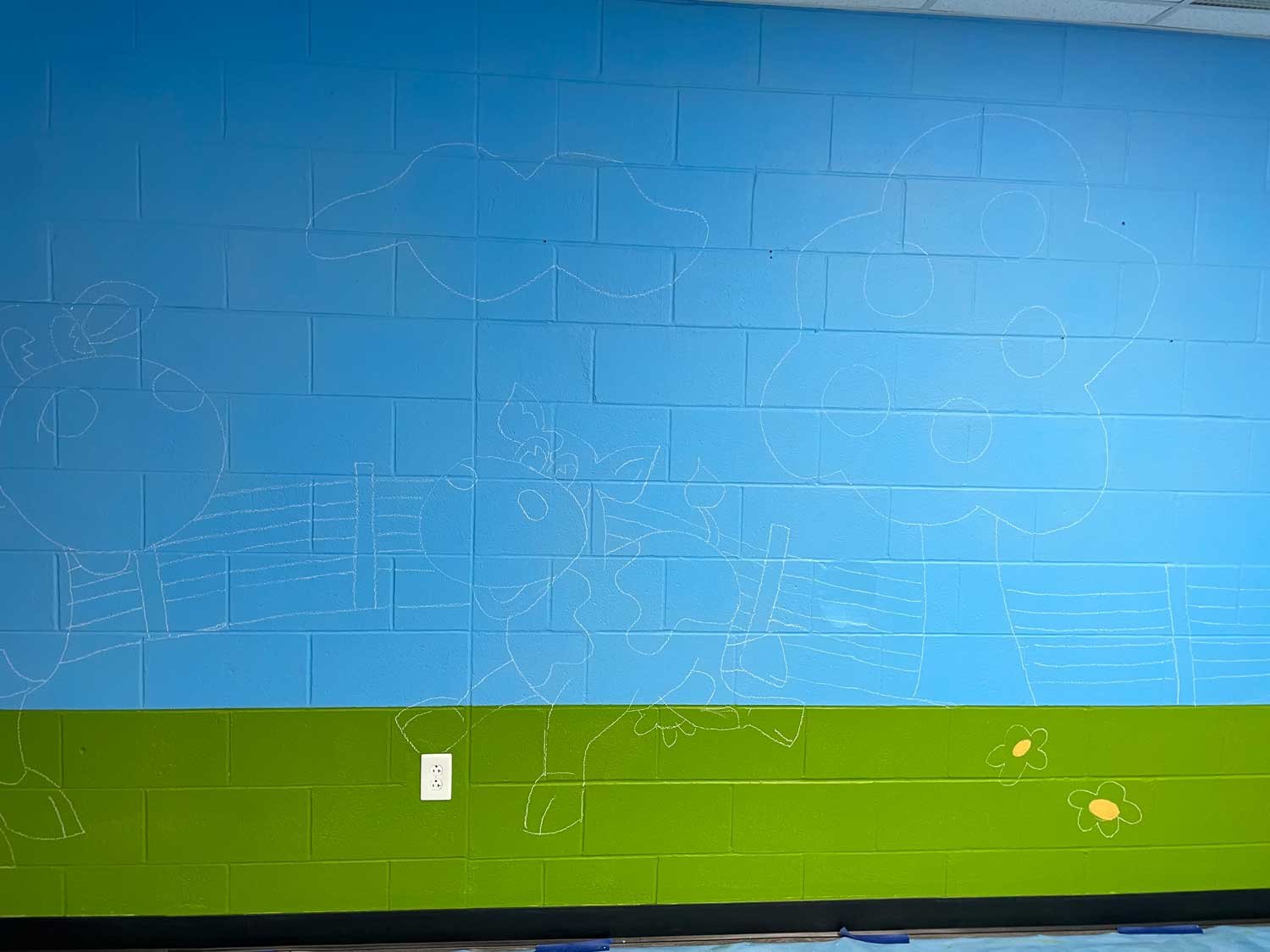 The walls were prepped prior to my arrival with blue sky and green grass