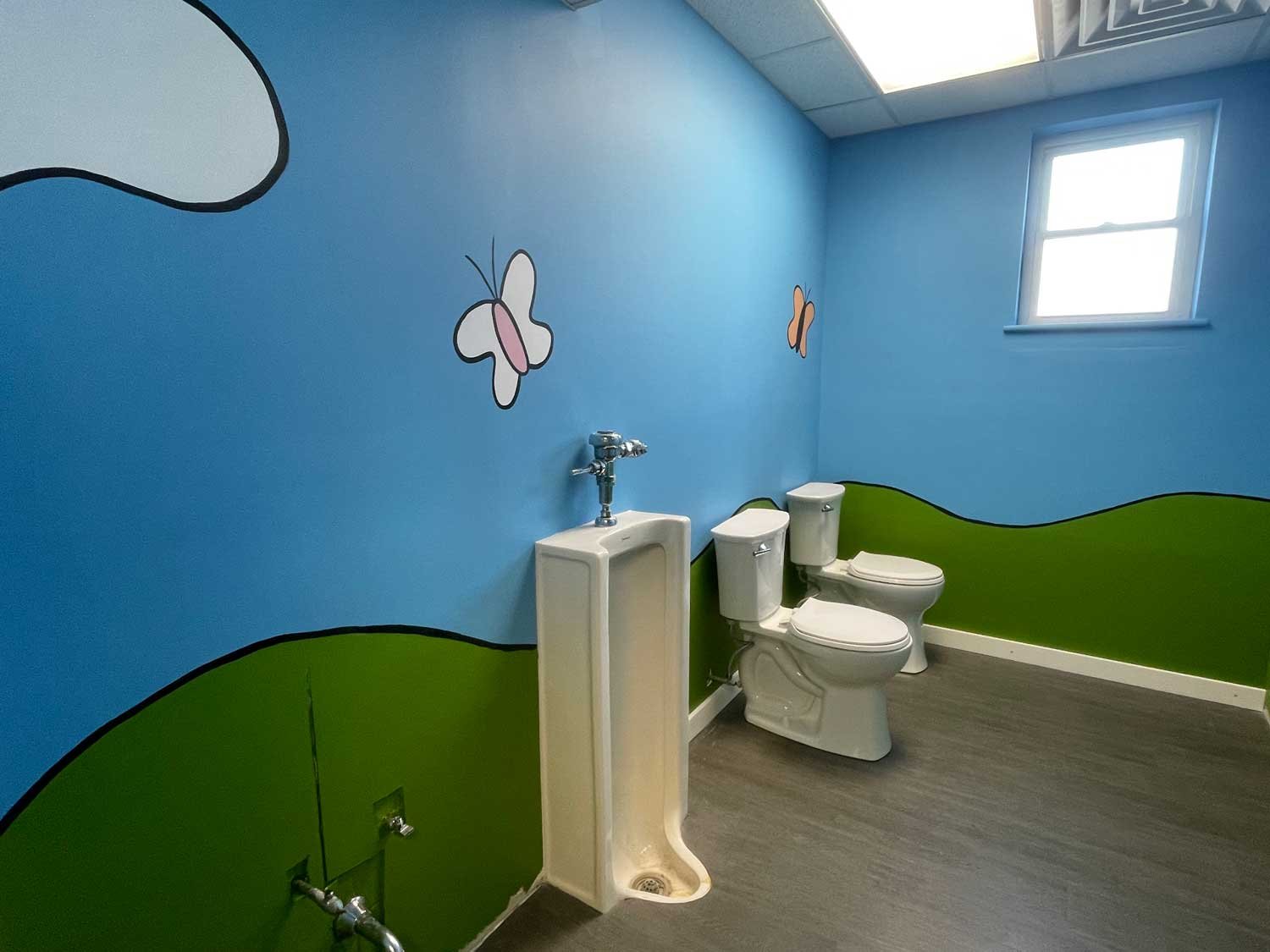 Boys Bathroom: The mural is complete – now just waiting for stalls