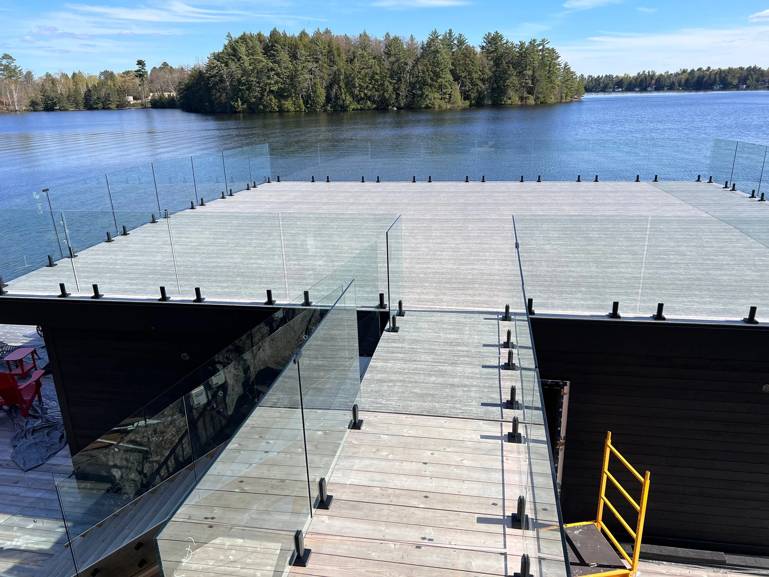 Glass railing on boat house in Muskoka over looking water