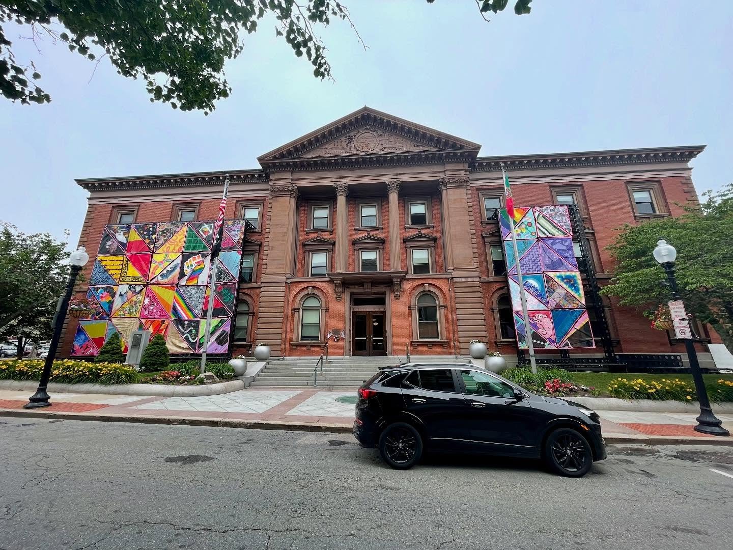 &ldquo;Being Seen: Celebrating SouthCoast Pride&rdquo; is a multi-piece tapestry created by more than 100 locals who decorated pieces of sail cloth which were then assembled into this enormous tapestry that currently sits in front of New Bedford City