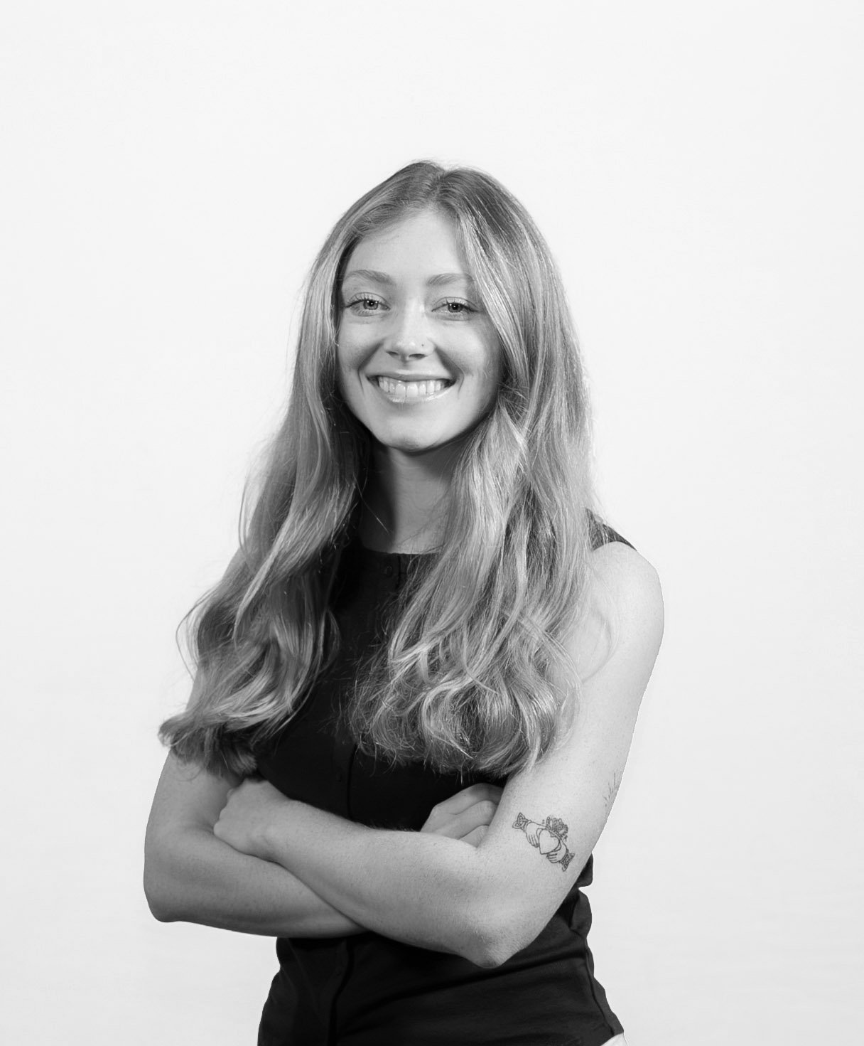 Headshot of Ava Soucy, smiling with arms crossed