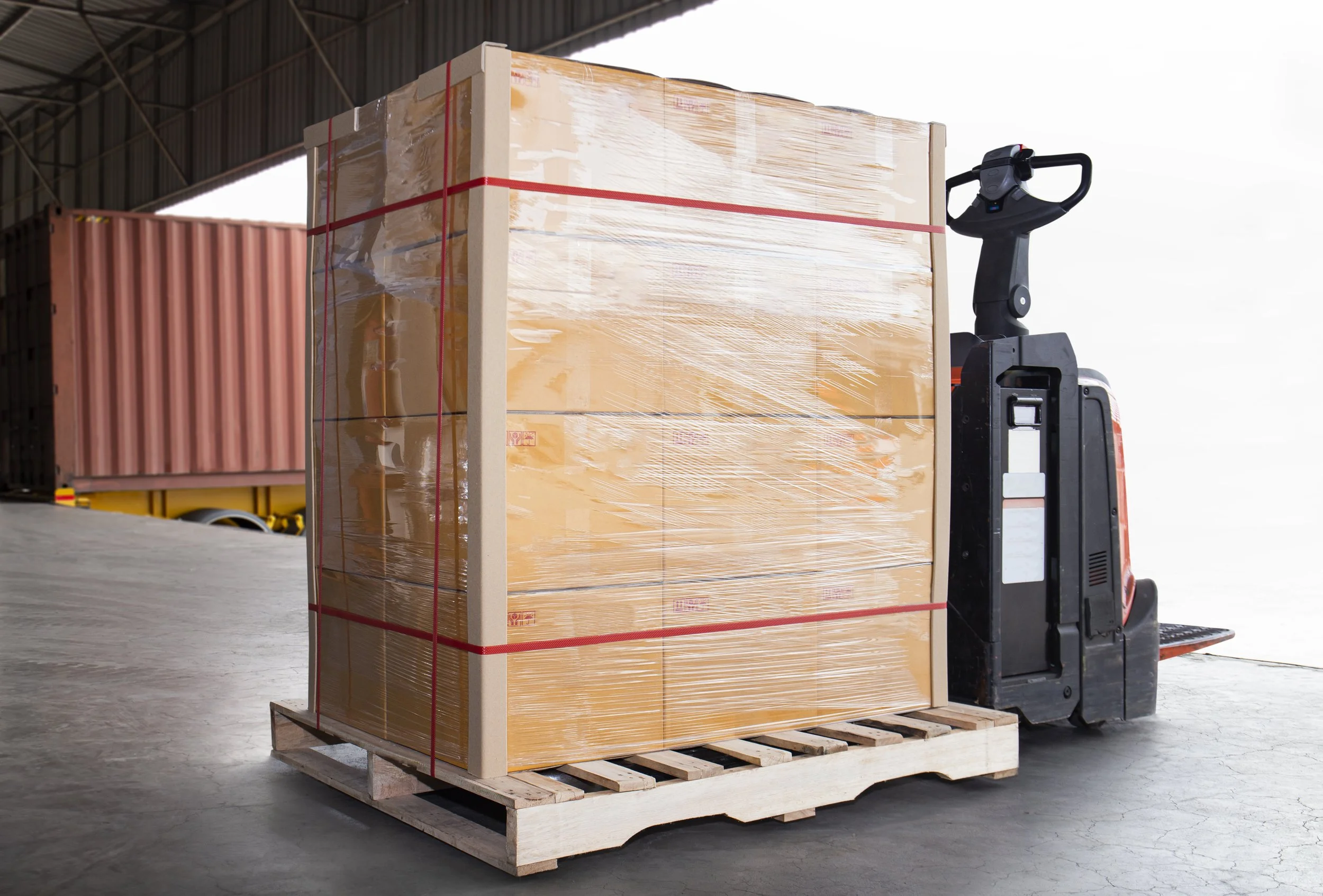 Shrink-wrapped pallet of boxes on a pallet jack ready to load for LTL shipping