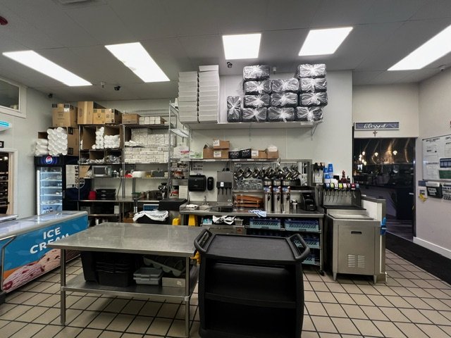  renovated kitchen workspace with storage and appliances - side view with entrance to restaurant 