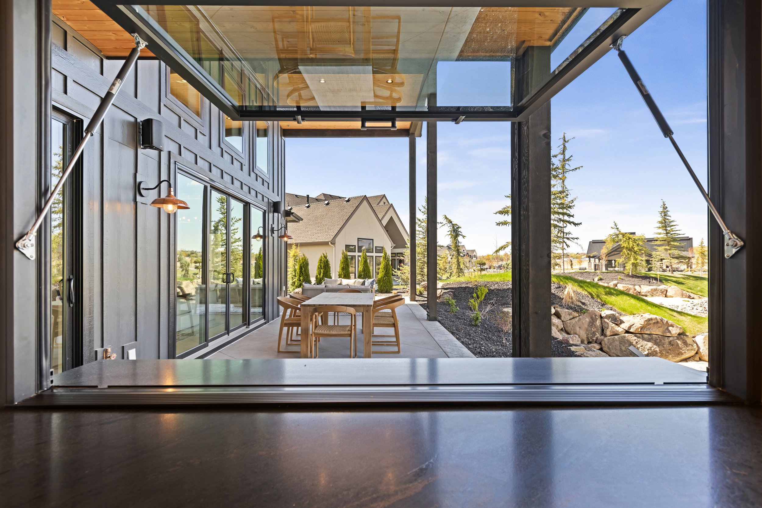 Pass-through window opening from the kitchen to a covered outdoor patio in The Bowers, a parade home by Bachman Custom Homes in Terra View, Eagle, Idaho