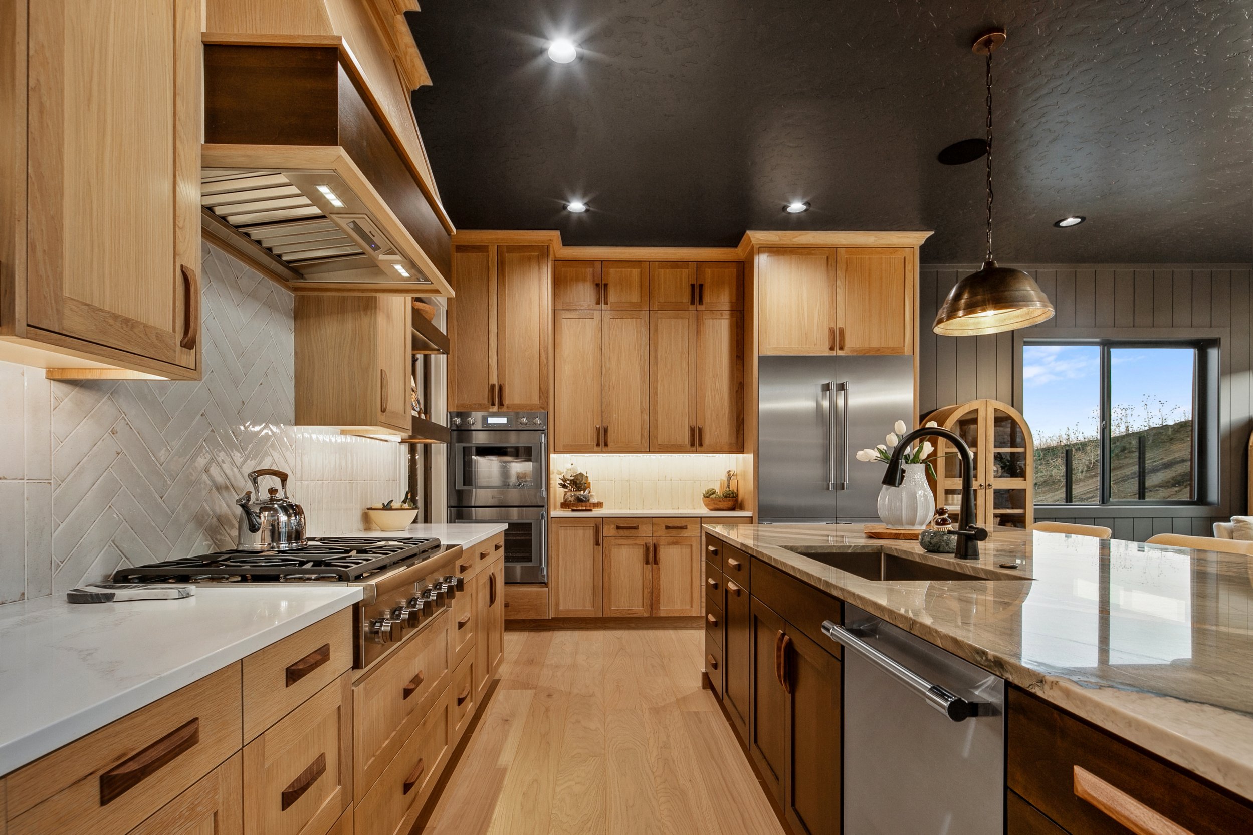 Standard kitchen features in a Bachman custom home - Thermador appliances and custom cabinetry