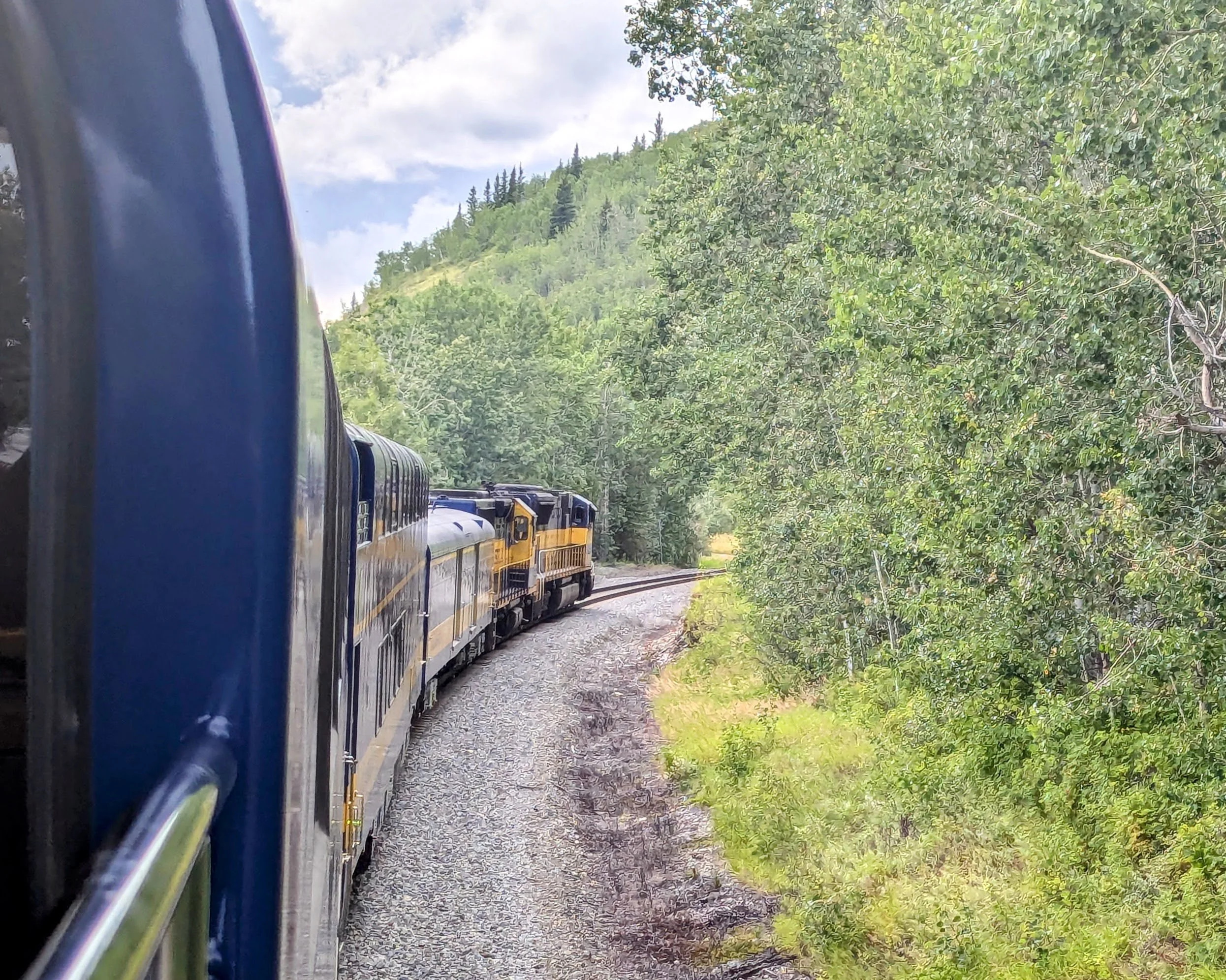 Alaska Railroad journey to Denali National Park with mountain views from outside viewing platform