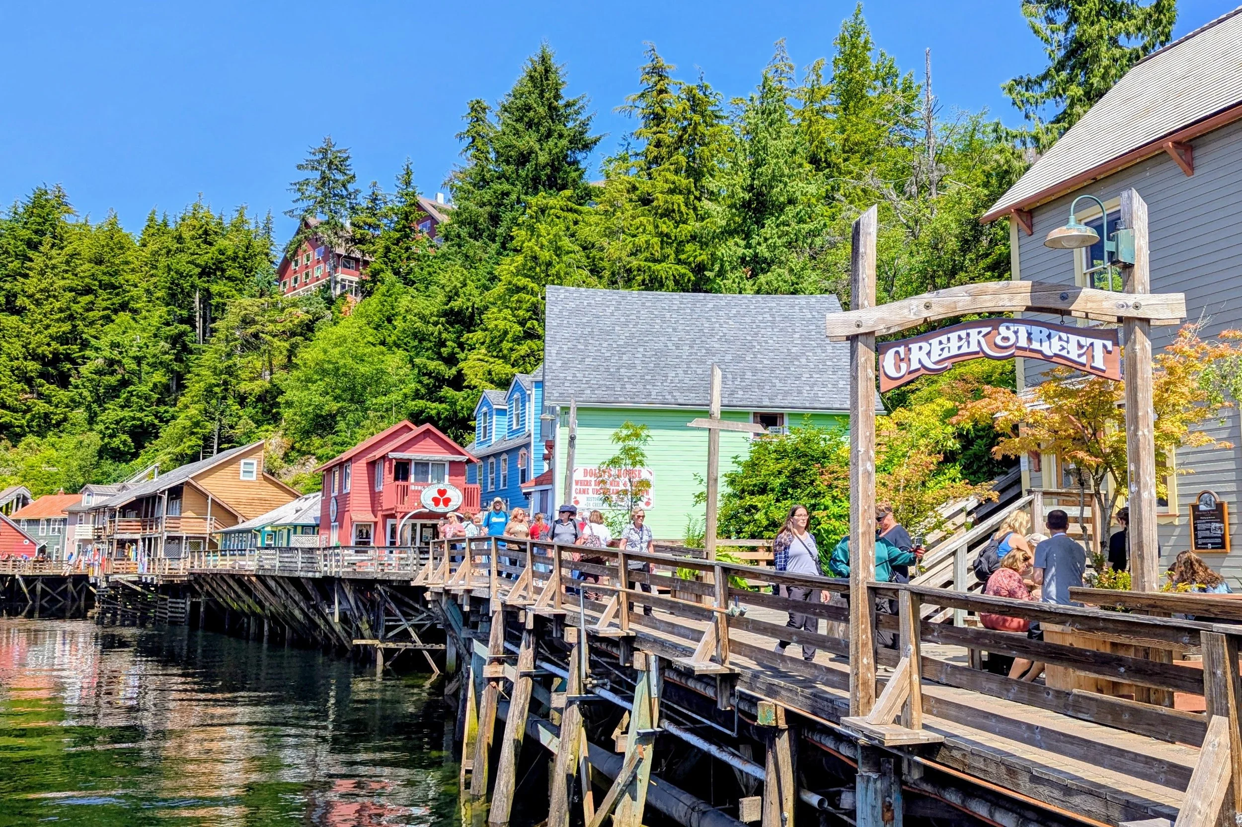 Visitors walking through downtown Creek Street in Ketchikan, Alaska on a cruise port day