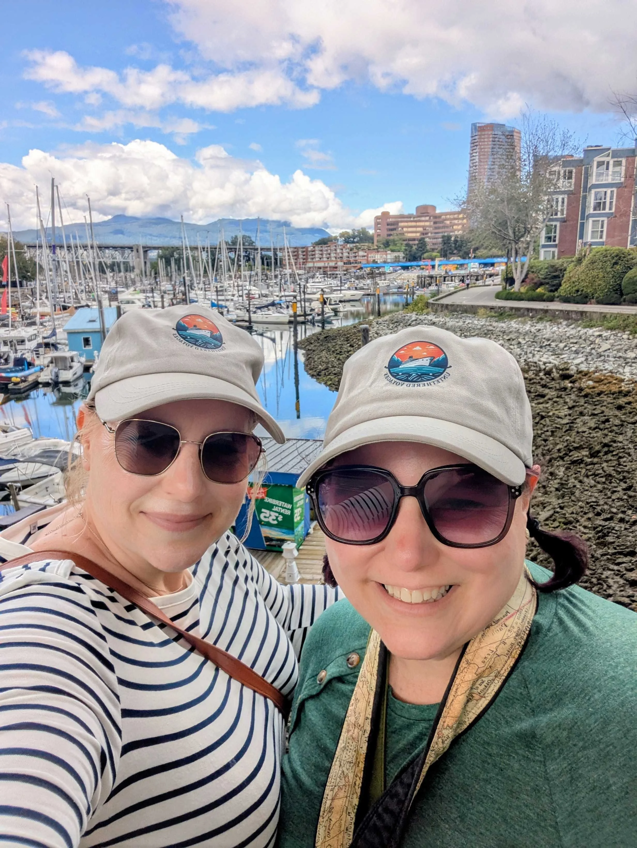 Two women standing in front of a Vancouver Harbor in Granville Island