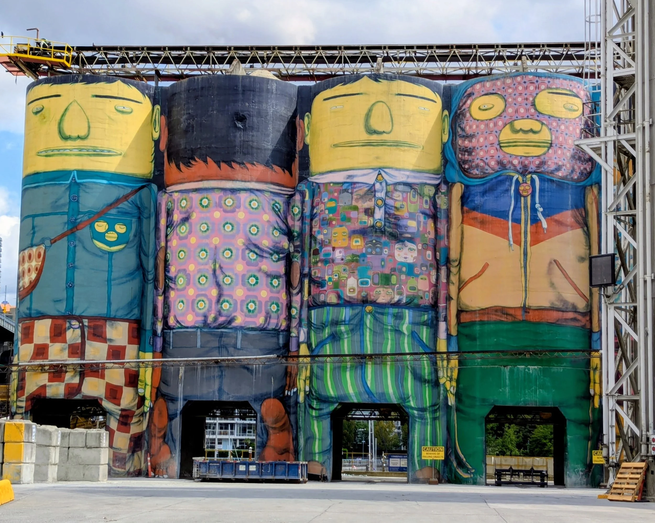 Massive murals of a colorful crew of giants by French street artist