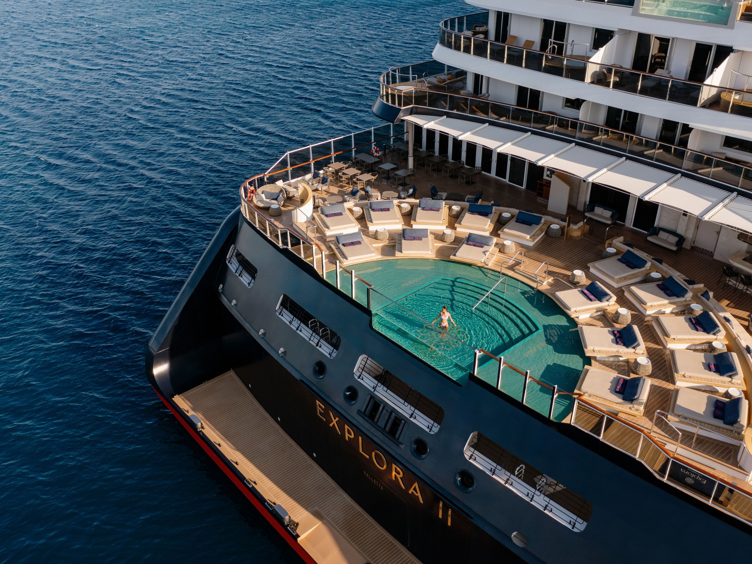 Explora Journeys luxury ship ocean Astern pool with serene ocean backdrop