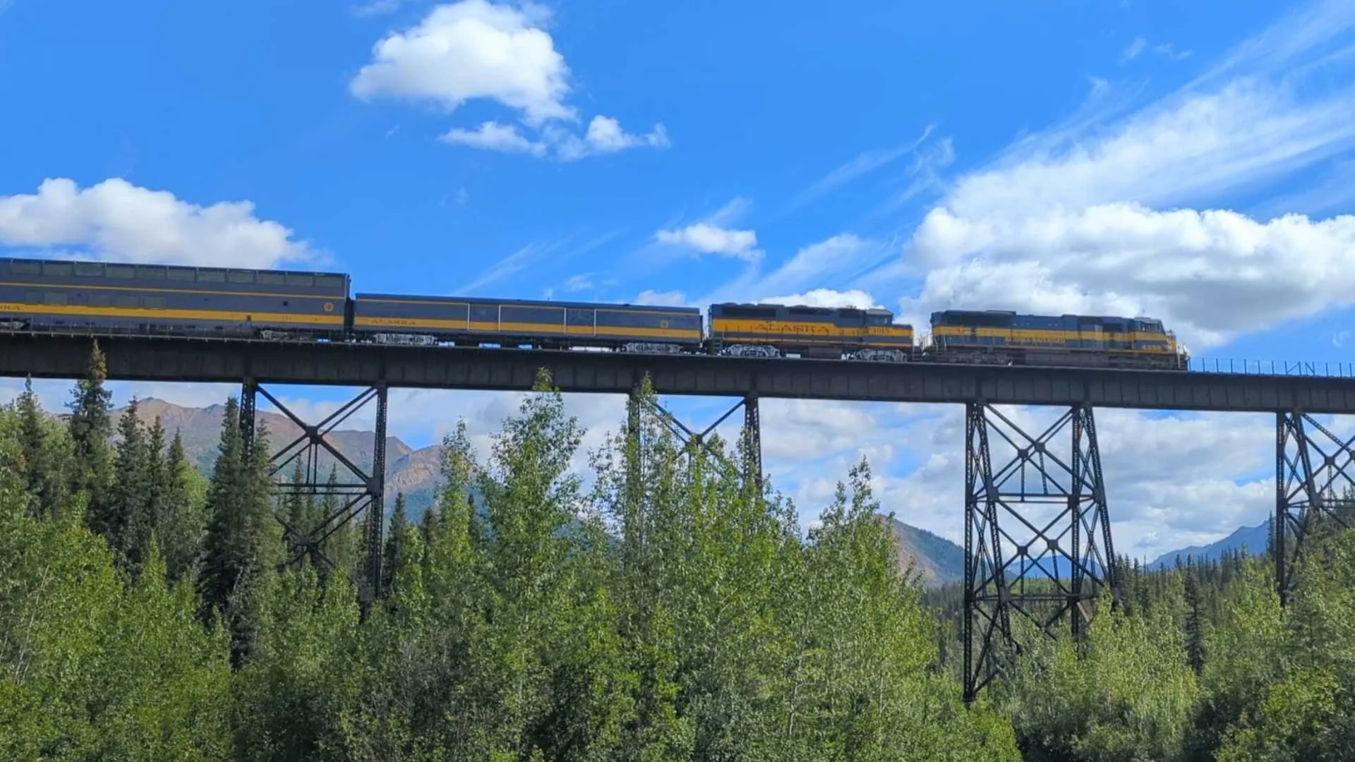 View of the Alaska Railroad's Denali Star on a tressle bridge above Denali National Park