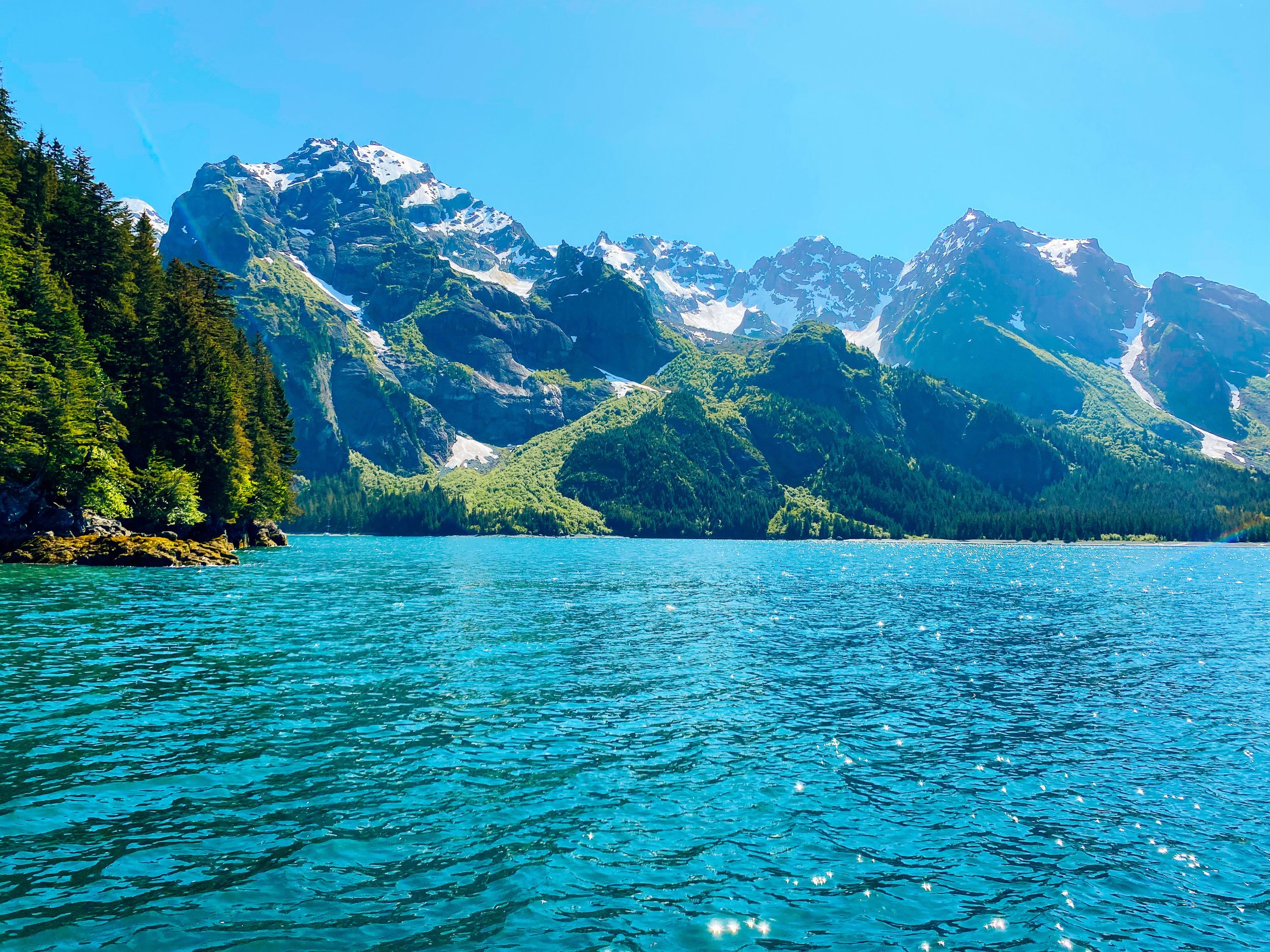Dramatic Alaska Inside Passage scenery with snow-capped mountains reflected in calm water