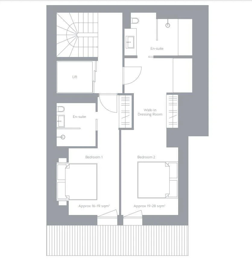 Floor plan of a residential space showing two bedrooms, each with an en-suite bathroom, walk-in dressing room, lift, and staircase.