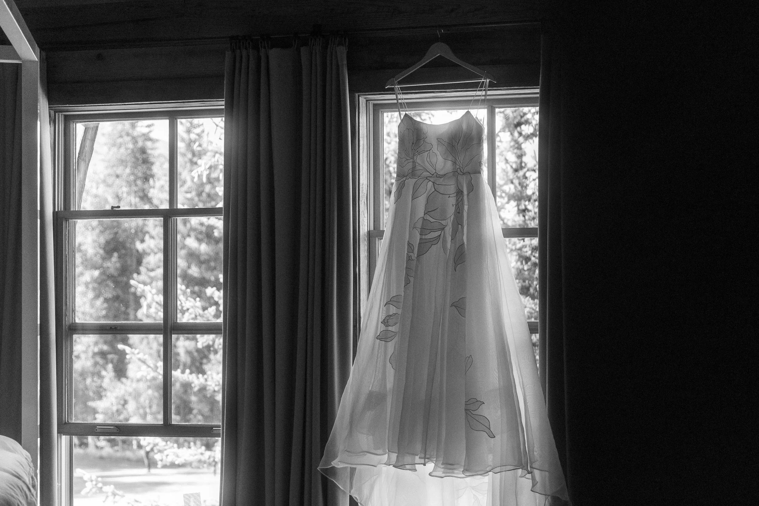 A wedding dress hanging in the window at a wedding in Crested Butte, Colorado